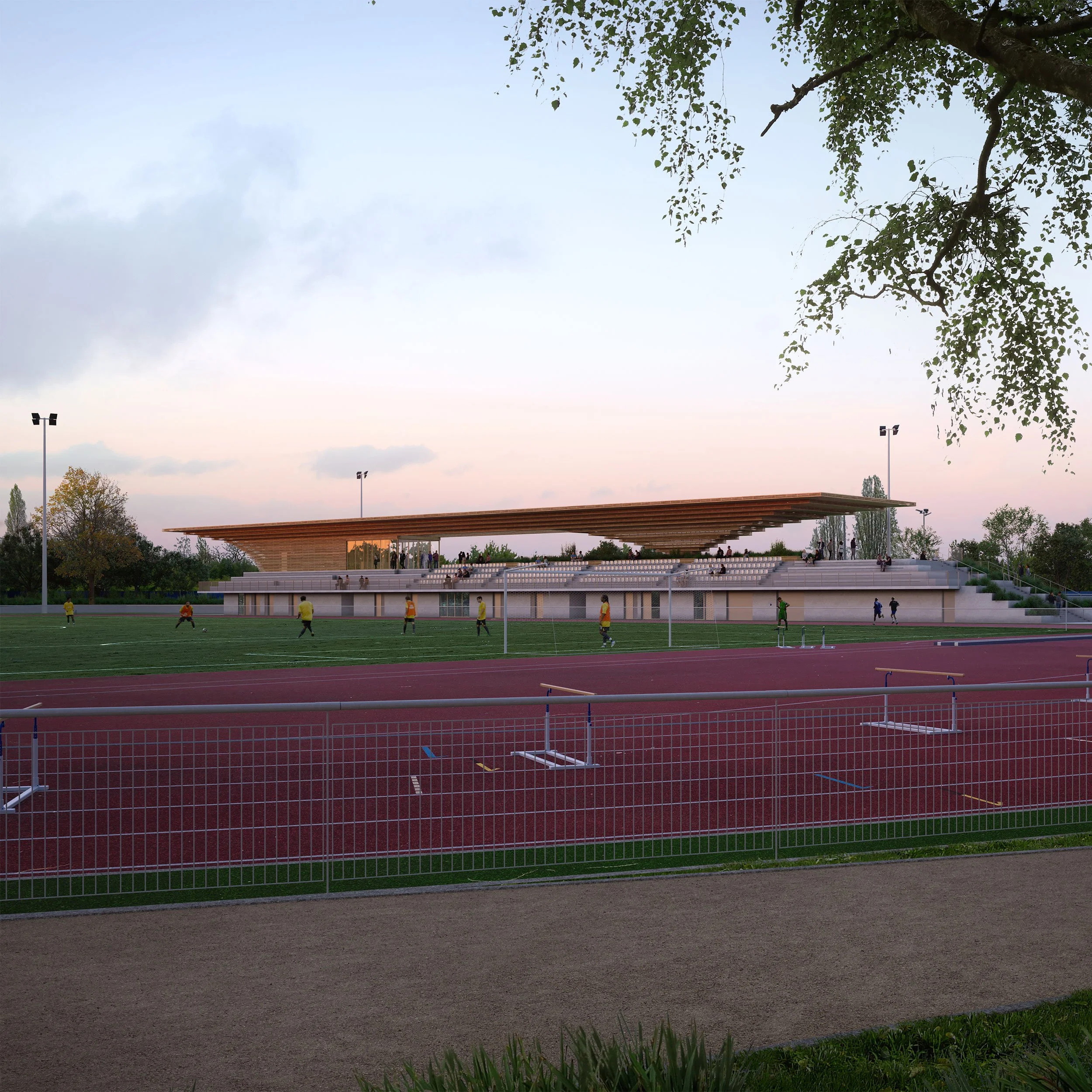 A modern sports stadium with a curved, wooden roof over seating area, surrounding a running track, and people playing or watching sports during dusk.