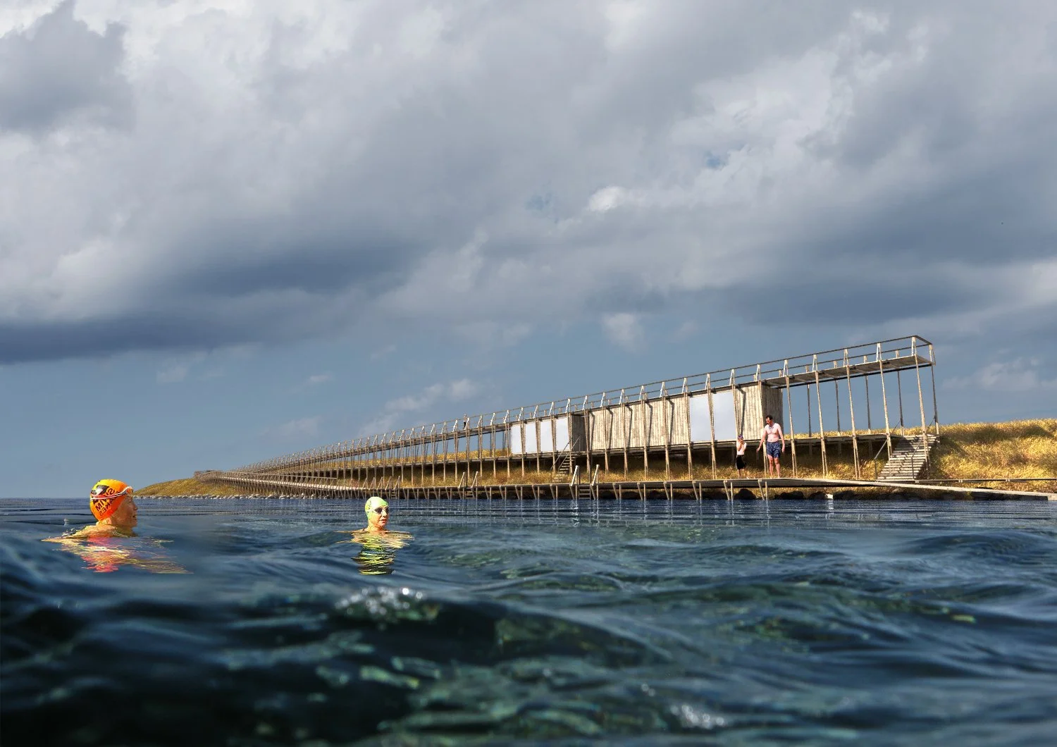 Two swimmers in the water near a wooden dock or pier, with a cloudy sky in the background and a small structure on the shoreline.
