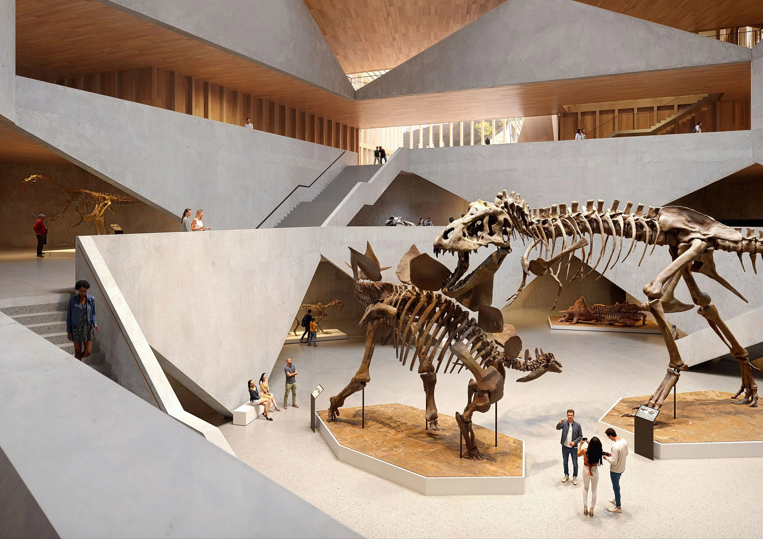 The interior of a modern art museum showcasing dinosaur skeletons, including a large Tyrannosaurus rex, with visitors exploring and observing the exhibits.
