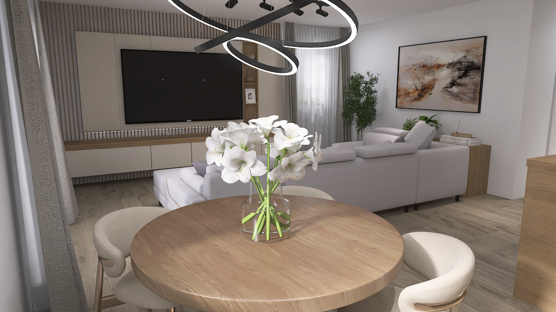 A modern living room with a round wooden dining table, a vase of white flowers, a gray sectional sofa, a large wall-mounted TV, framed abstract art, and contemporary lighting fixtures.