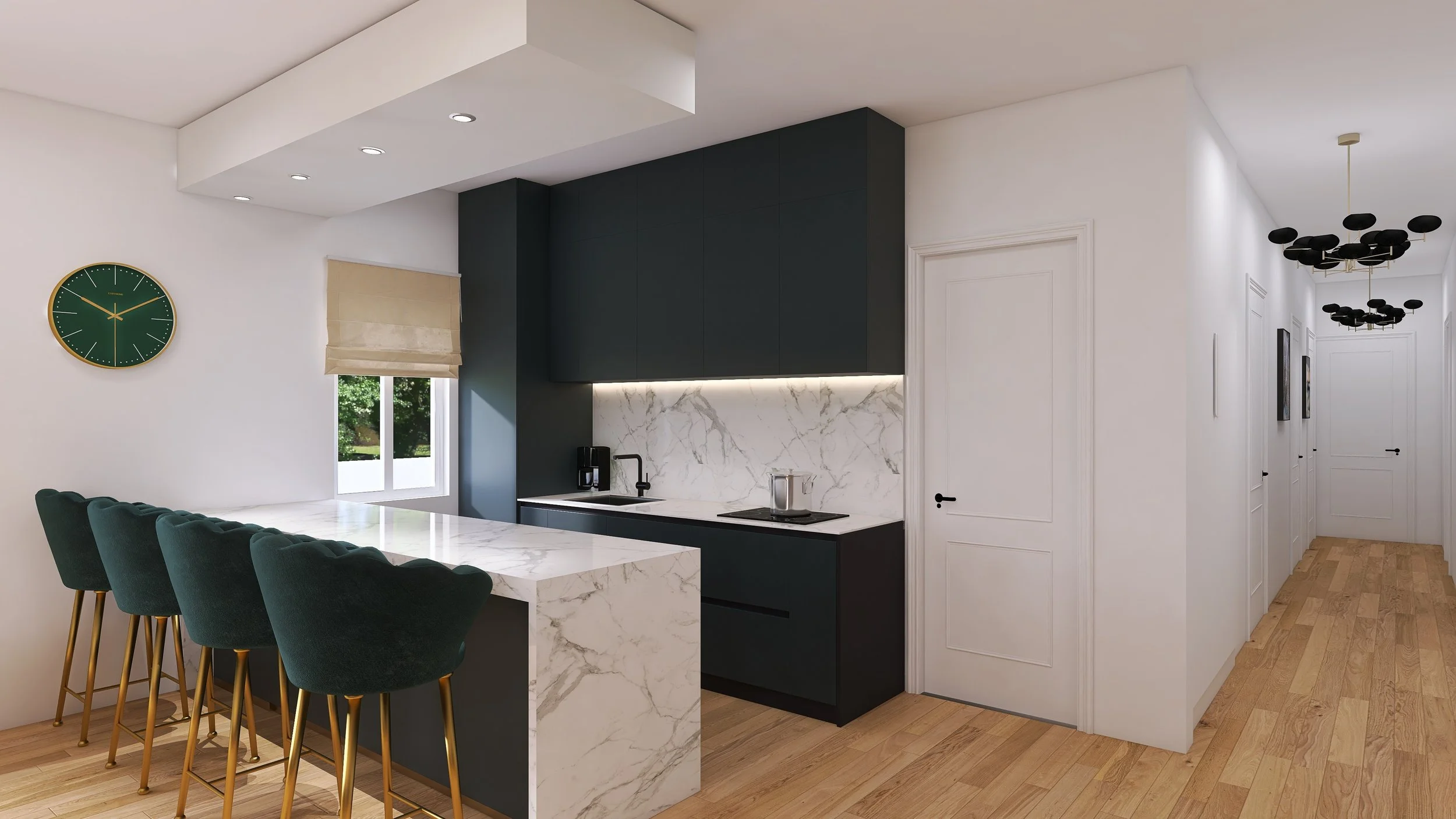 Modern kitchen with white marble countertops and backsplash, dark upper cabinets, white walls, wooden flooring, a row of four green velvet barstools with gold legs at the kitchen island, a green wall clock, window with beige roman shade, and hallway with black ceiling lights.