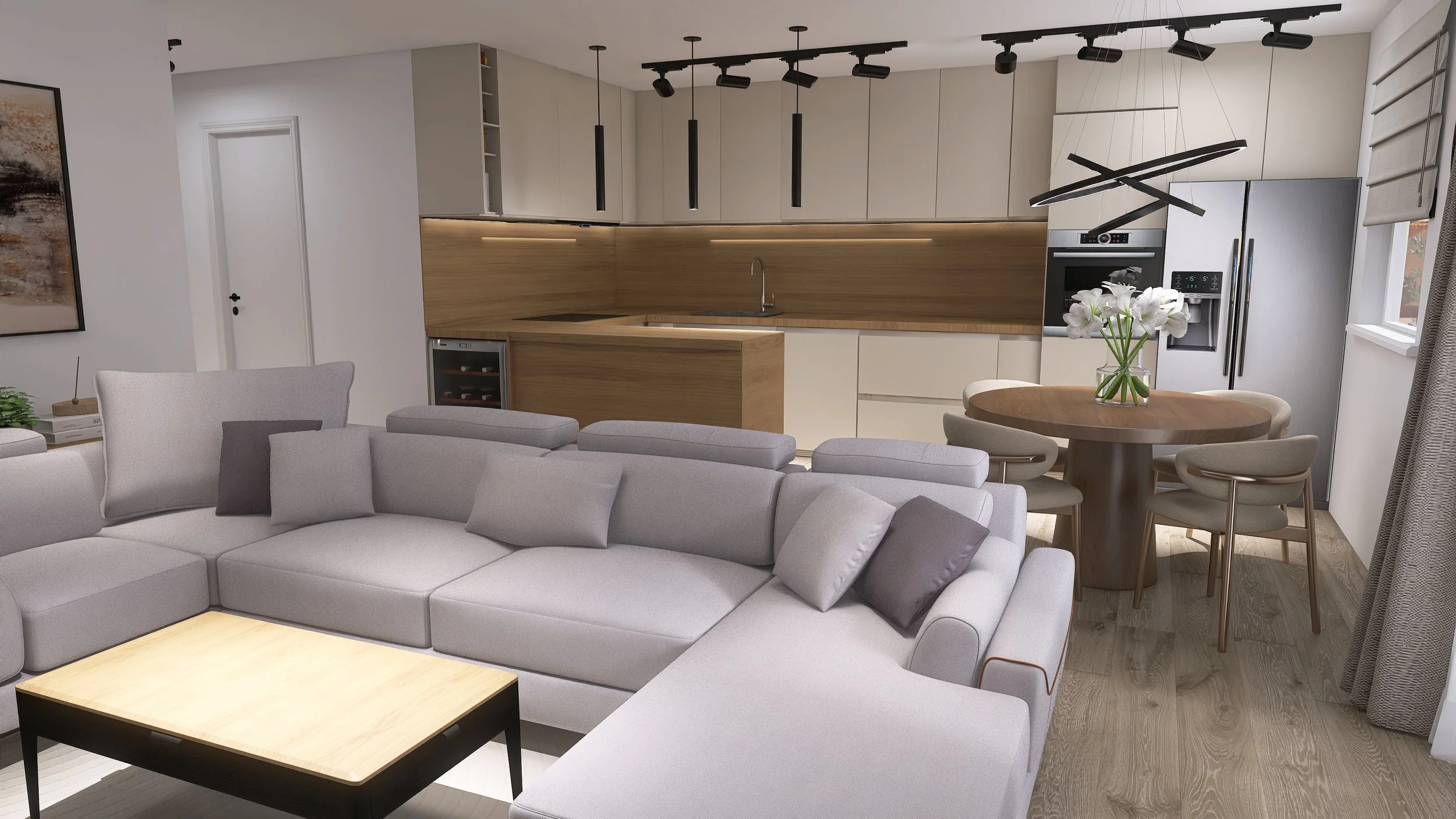 Modern kitchen and living room area with gray sectional sofa, wooden coffee table, round dining table with chairs, and white cabinetry with black pendant and track lighting.