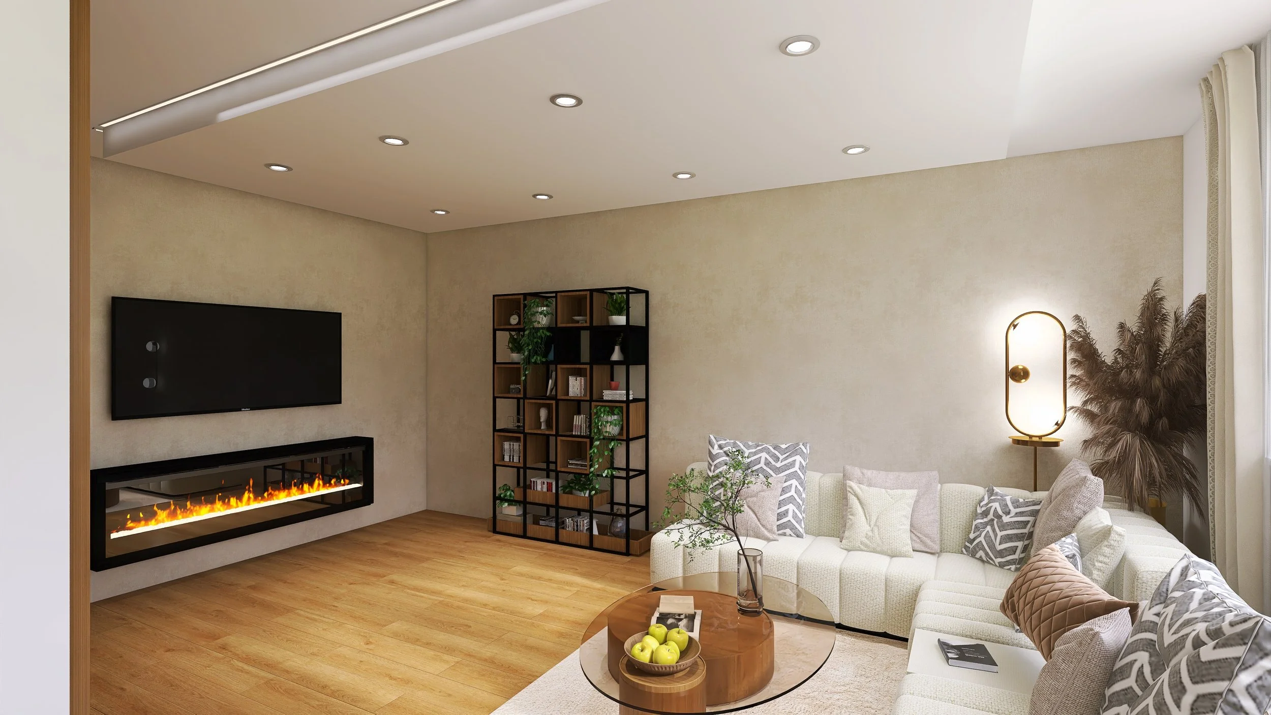 Modern living room with a white sectional sofa, patterned cushions, wooden coffee table with apples and a vase, flat-screen TV, electric fireplace, bookshelf with decorations, and a tall lamp with a warm glow.
