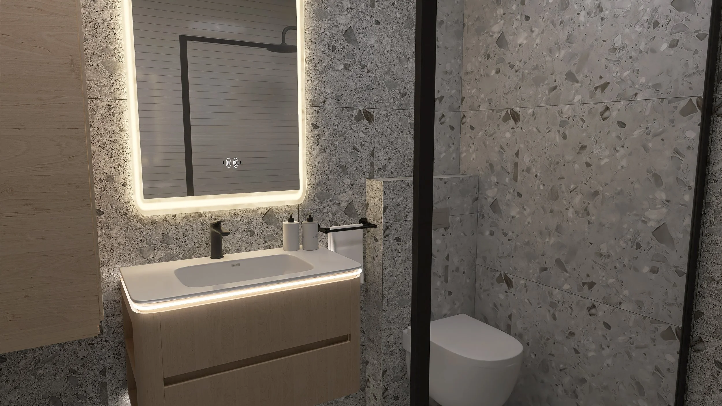 Modern bathroom with a backlit mirror above a white sink vanity and a toilet, surrounded by terrazzo wall tiles.