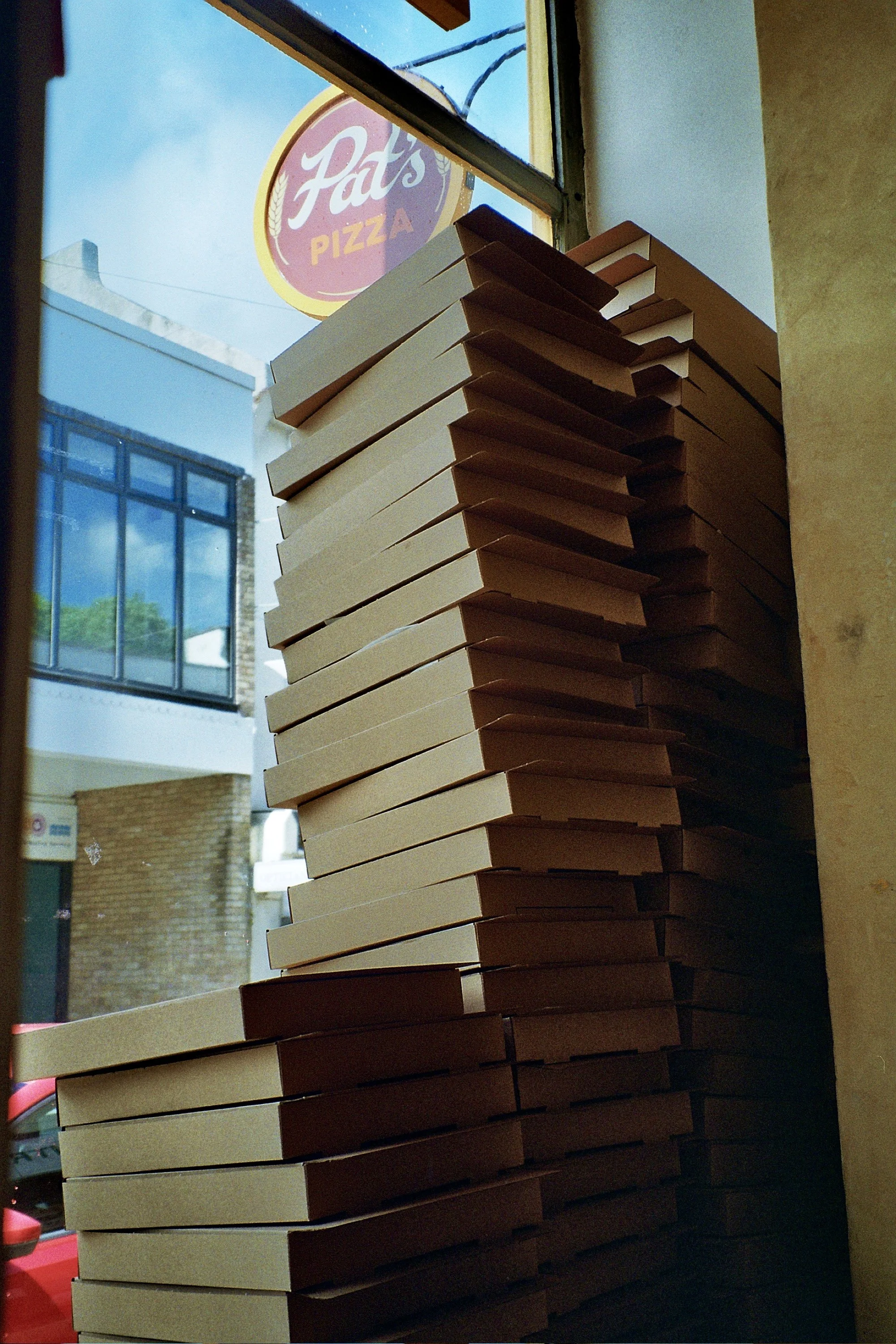 pizza boxes in the window of the Pat's pizza Newhaven shop