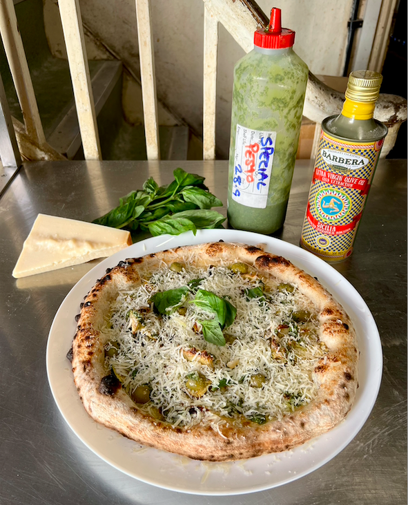 Pat's pizza special for june with whipped ricotta, confit garlic, lemon base and courgette, artichoke, green olives with a lemony pesto and lashings of parmesan.