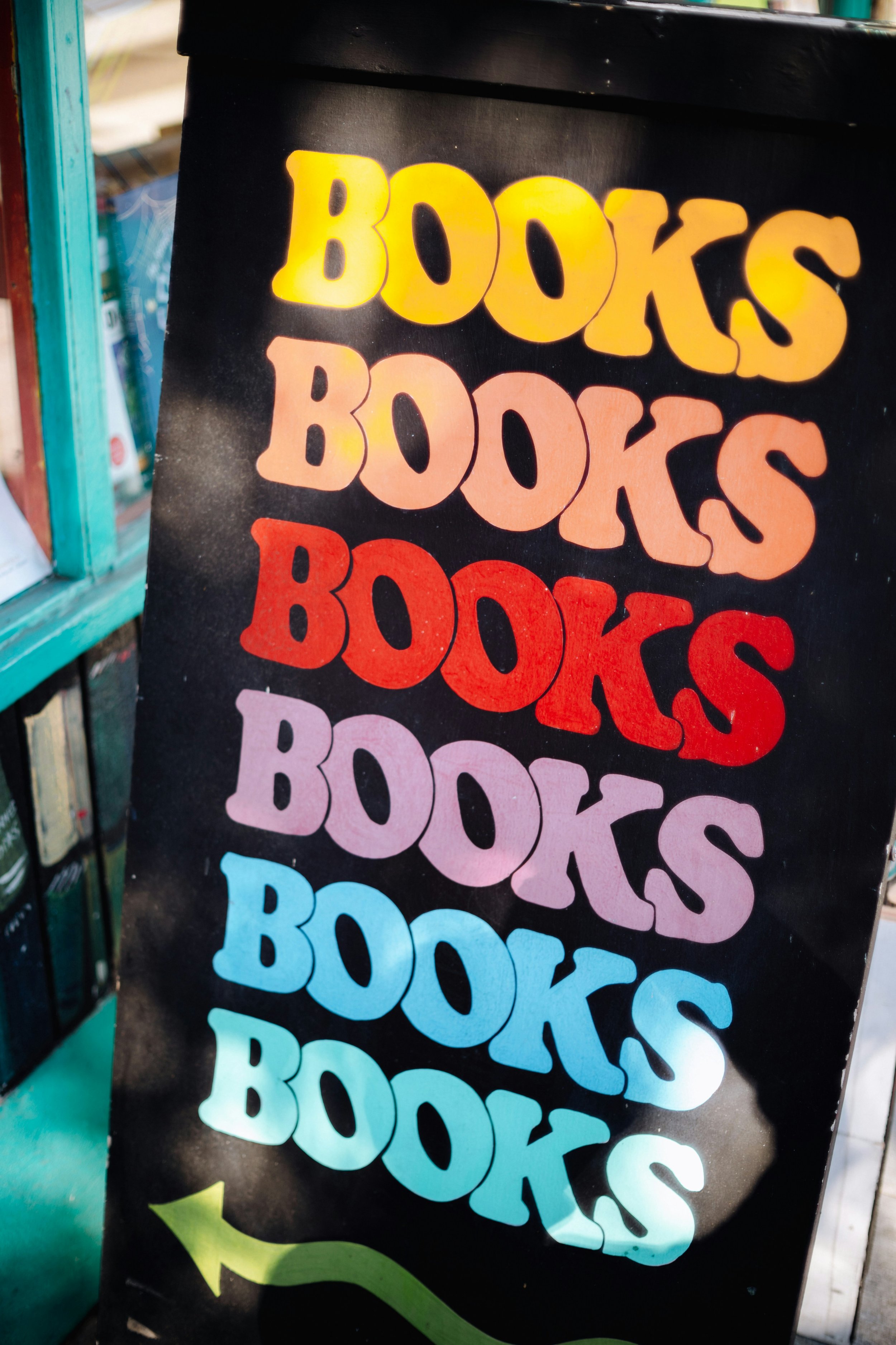 Sign that says "BOOKS" in different colors. Photo by Jason Leung on Unsplash.