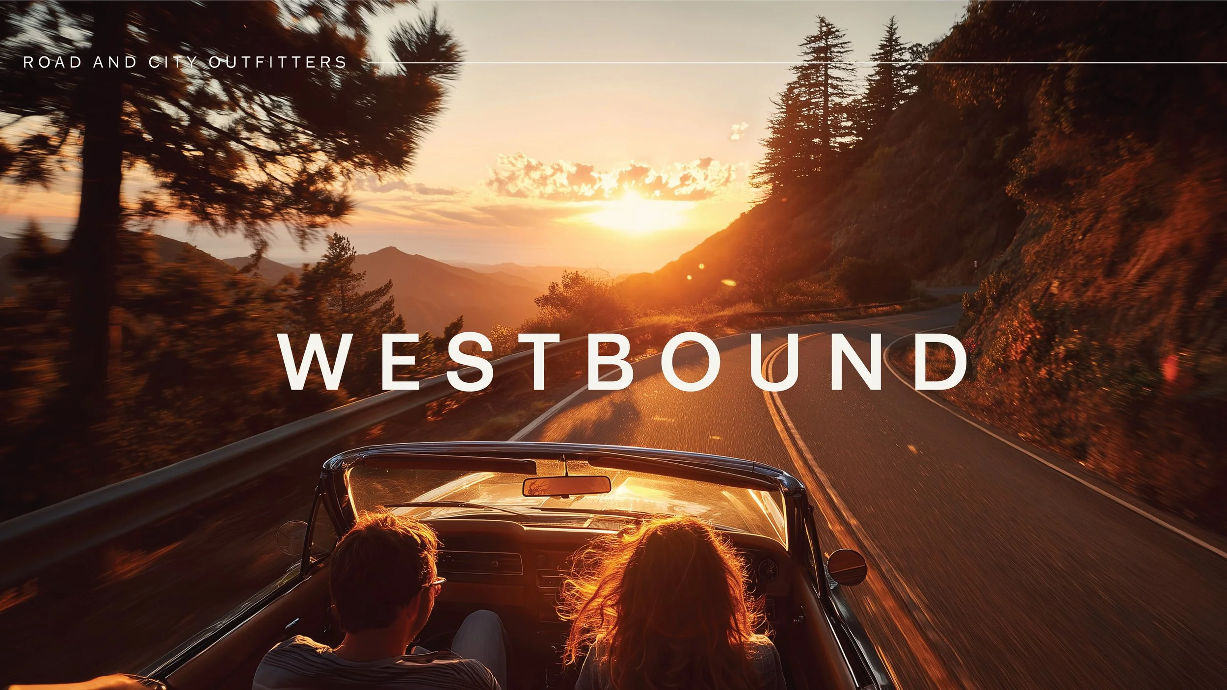 A car with two passengers driving on a winding mountain road during sunset, with trees on both sides and a view of distant mountains.