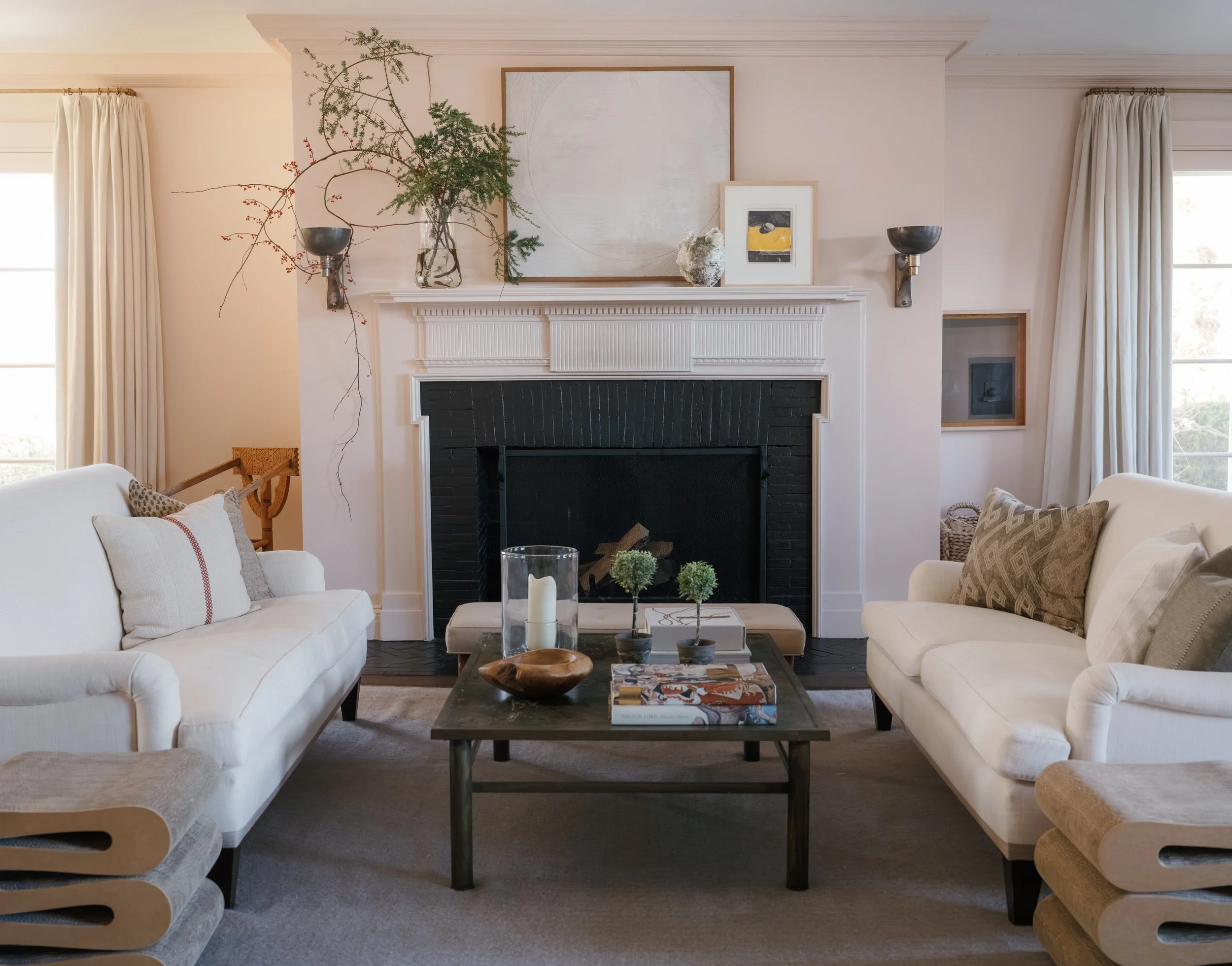 Elegantly styled living room with curated fine art above the mantel and collected decorative objects — Cecilia Wolfson Art Consulting