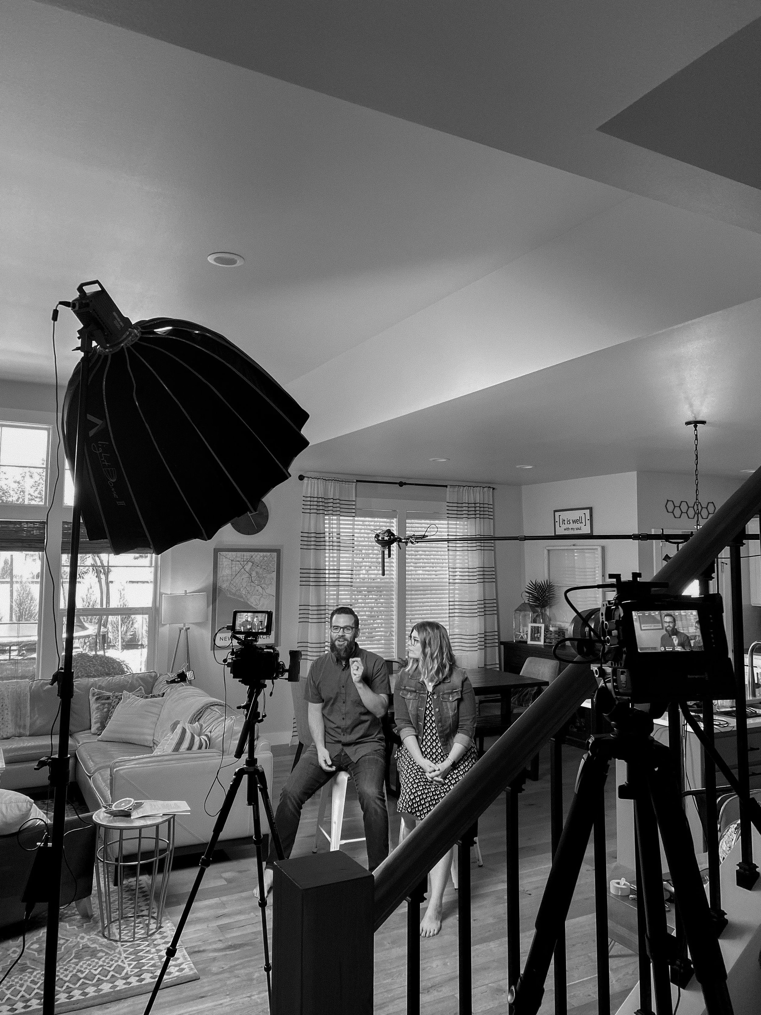 An in home video production set in Lynden, Washington featuring people sitting in frame, a microphone, and lights.