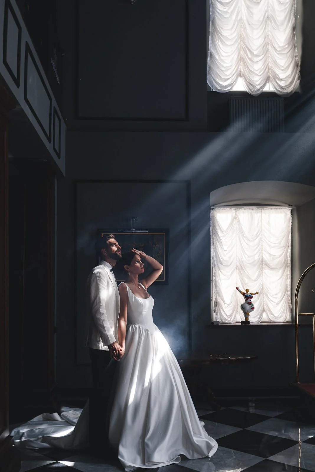 Newlyweds bathed in dramatic, cinematic light; high-end destination wedding; editorial photography by Cécile Wedding