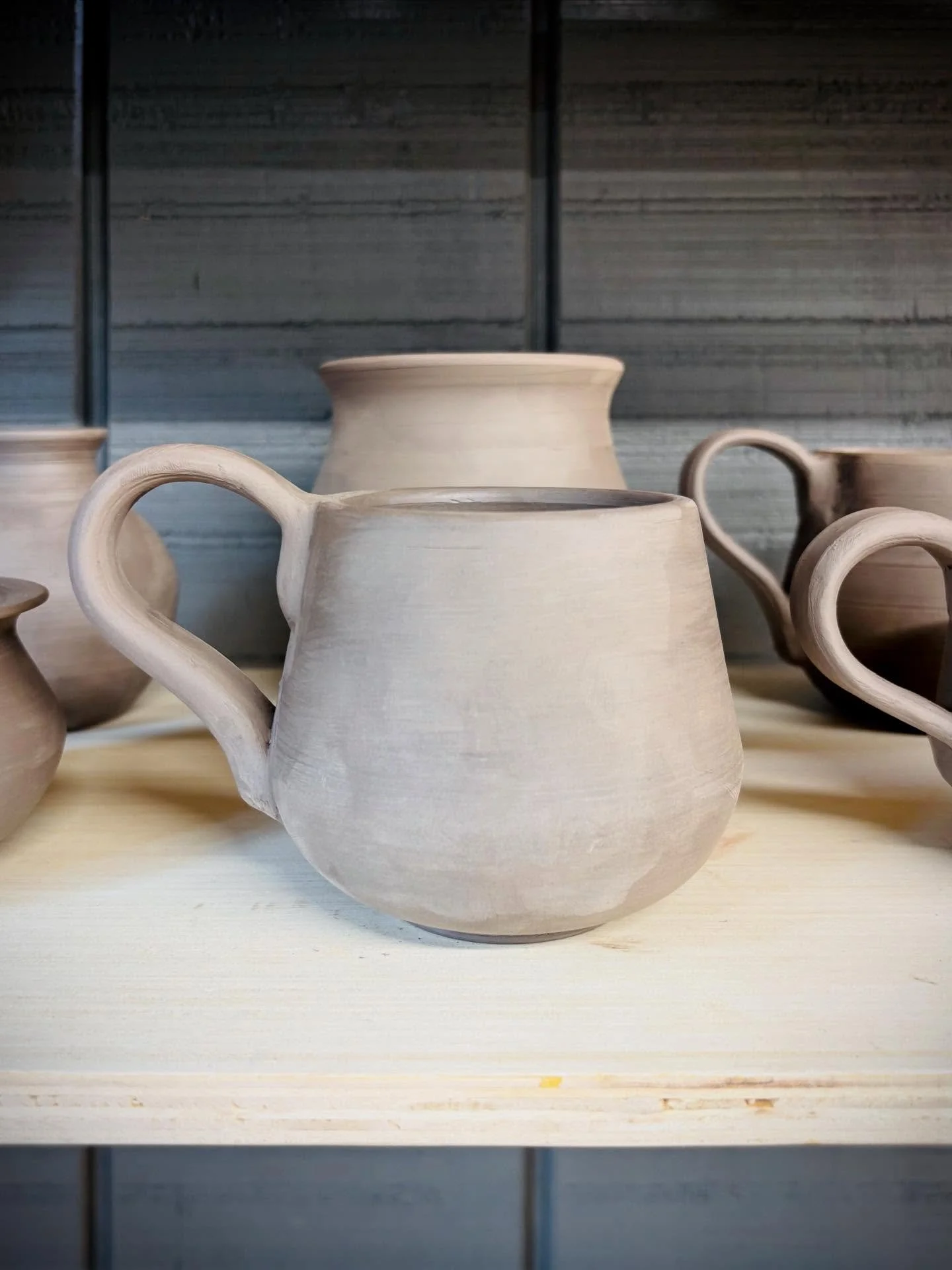 My second bisque firing is cooling down, and I&rsquo;m looking forward to glazing this mug tomorrow. Handles are harder than they look. Little things you don&rsquo;t expect create obstacles. This week has been hotter than usual, and my mug bodies dri