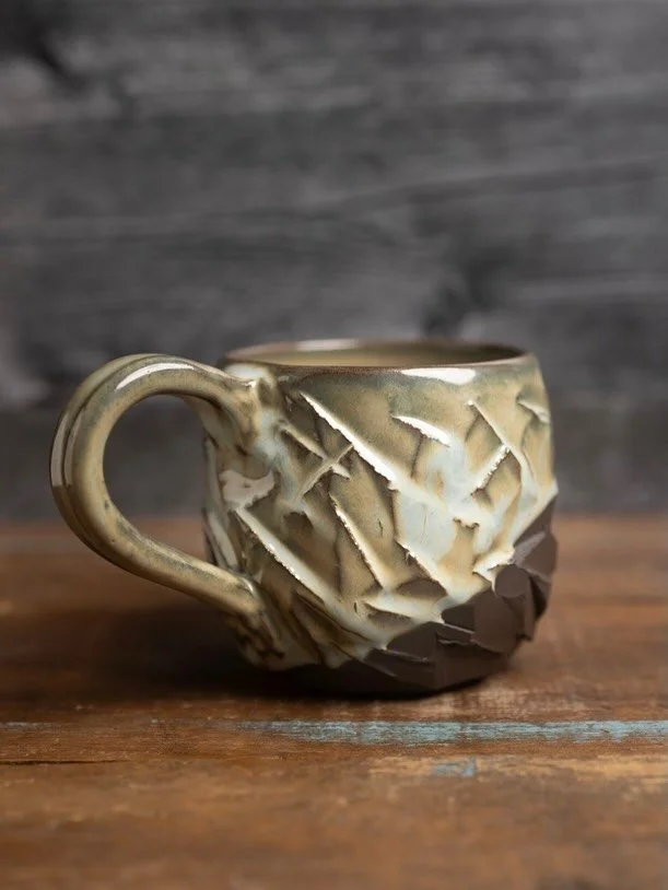 Three new pieces loosely inspired by the raw, carved spirit of Kurinuki pottery

Each begins with a rich dark chocolate brown clay body thrown on the wheel, then hand-carved for that organic, stoney texture. The first features a rugged, chipped surfa