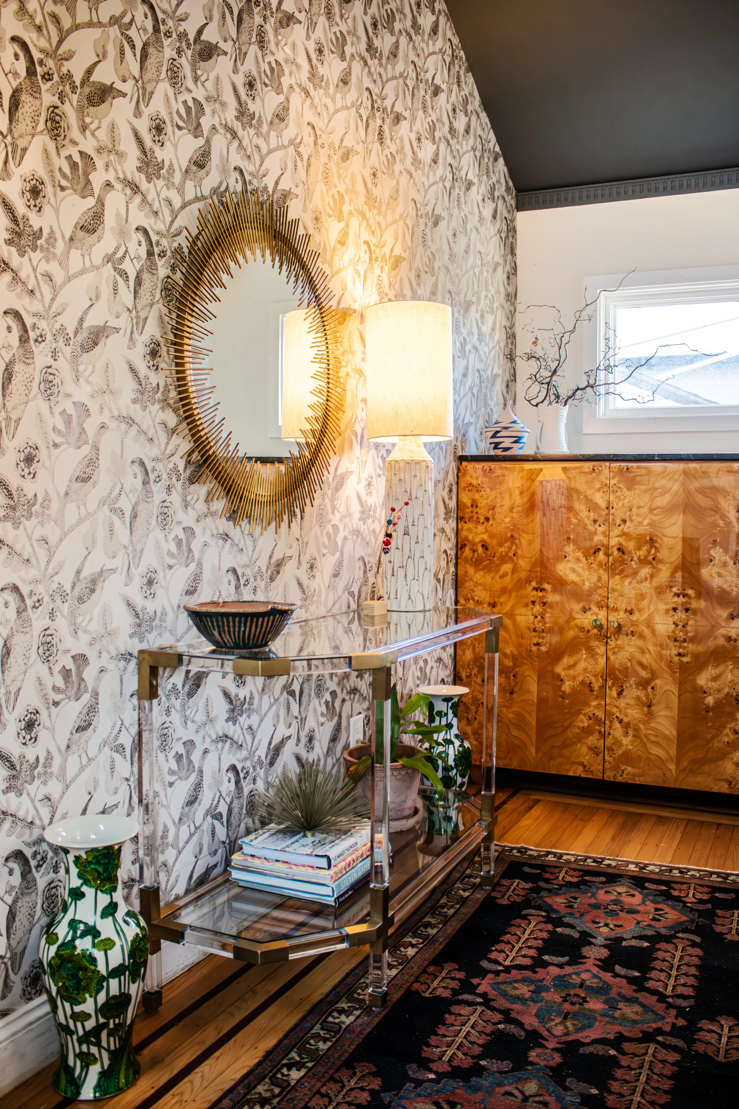 Floor to ceiling wallpaper makes a bold first impression in the entry, while custom built-in storage with burled veneer holds a stroller, shoes, bike supplies, and more. 

Construction: Hyperion Design and Build
