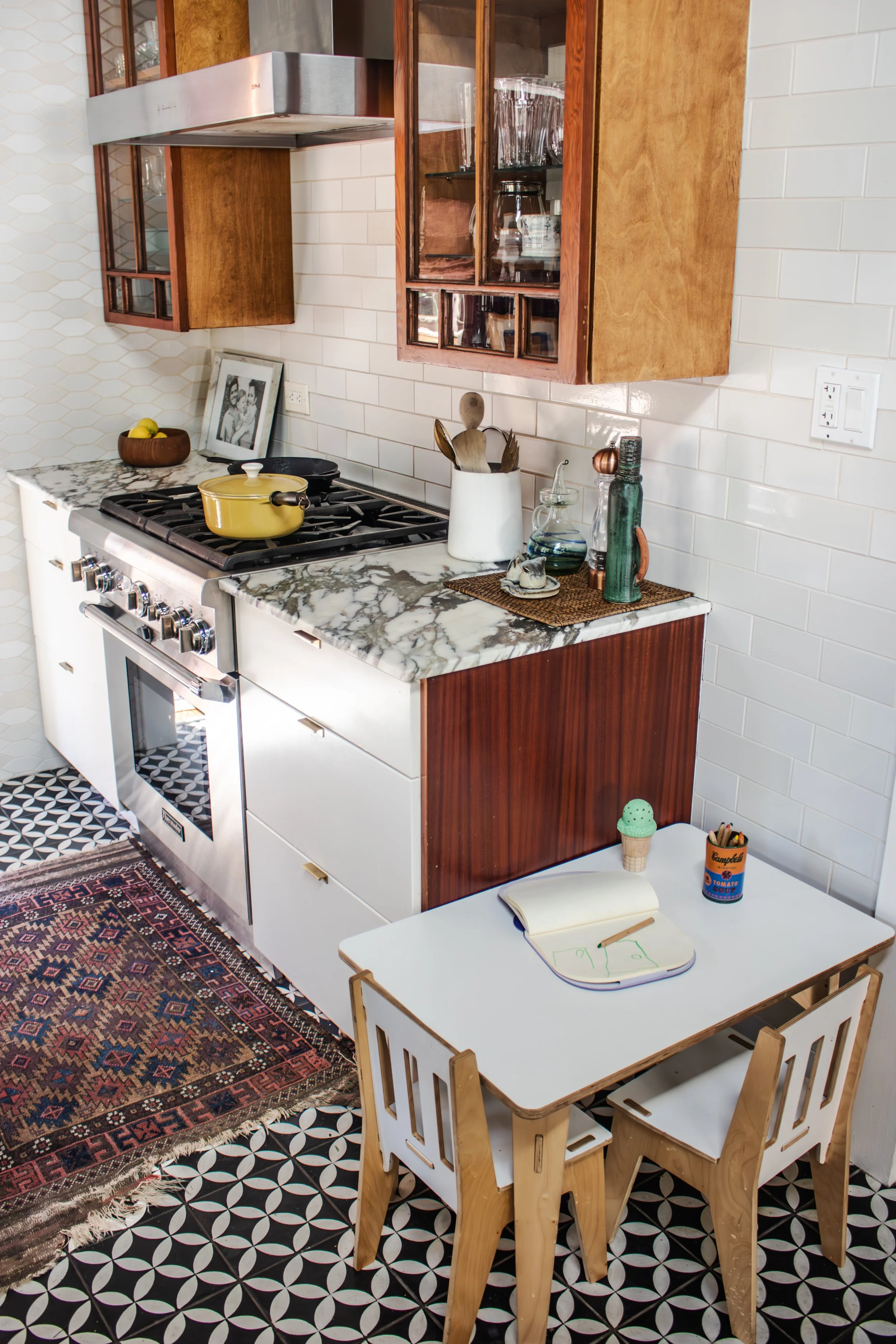 Two cabinet doors were salvaged from a storage unit in the basement and repurposed in the kitchen as a nod to the home's Craftsman origin.

Tile: Heath Overstock Shed
Construction: Hyperion Design and Build
