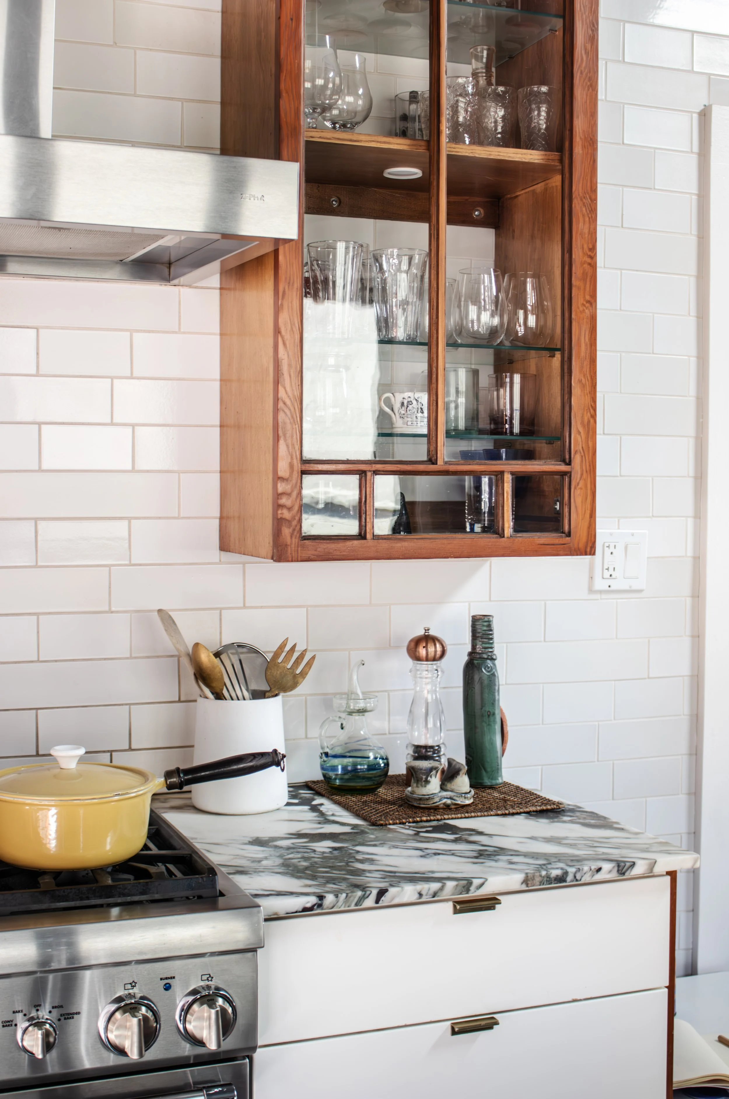 Two cabinet doors were salvaged from a storage unit in the basement and repurposed in the kitchen as a nod to the home's Craftsman origin.

Tile: Heath Overstock Shed

Construction: Hyperion Design and Build

