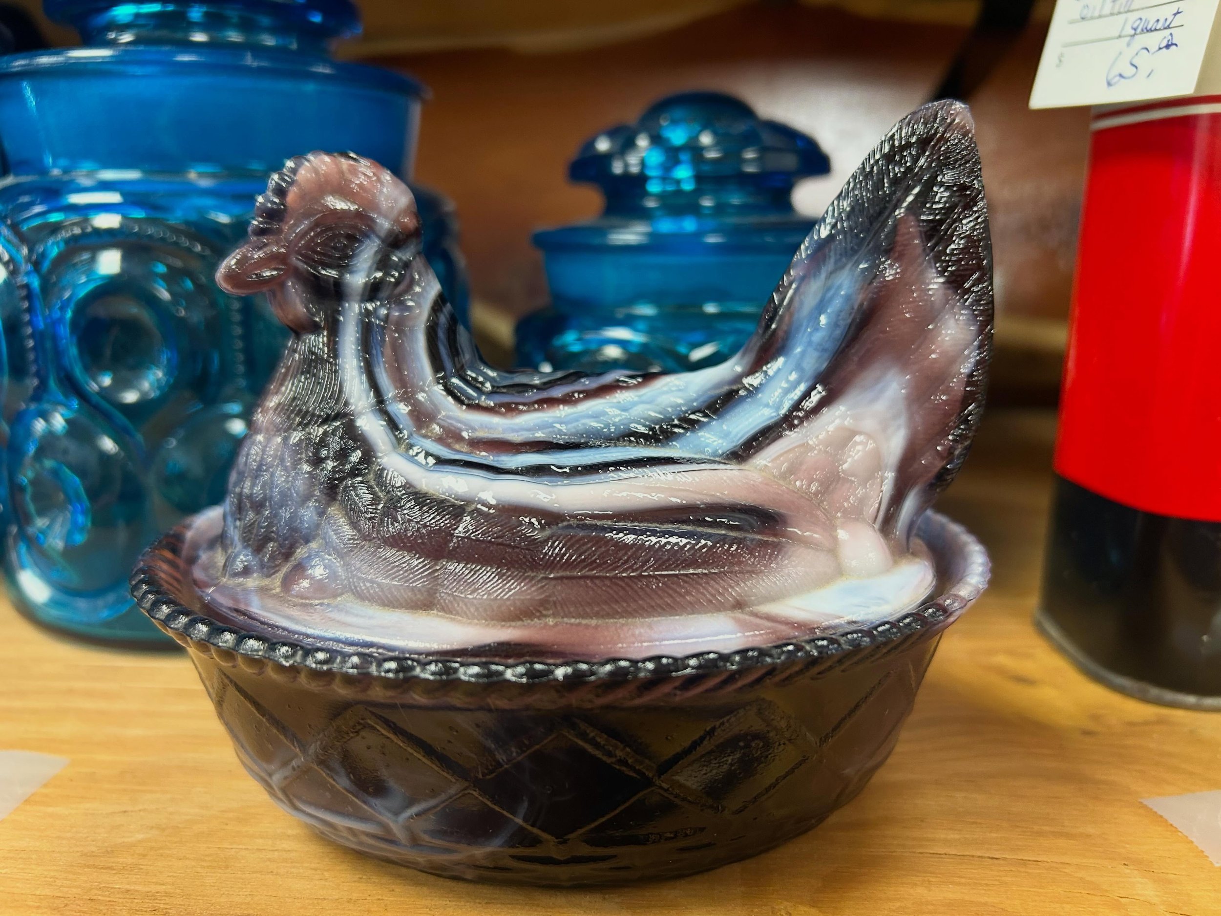 Looking for a fancy hen on nest to add to your collection?! Gotta love a purple slag glass piece by Westmoreland! 😍 Come check it out today from 10-5! 🌈🪩⚡️