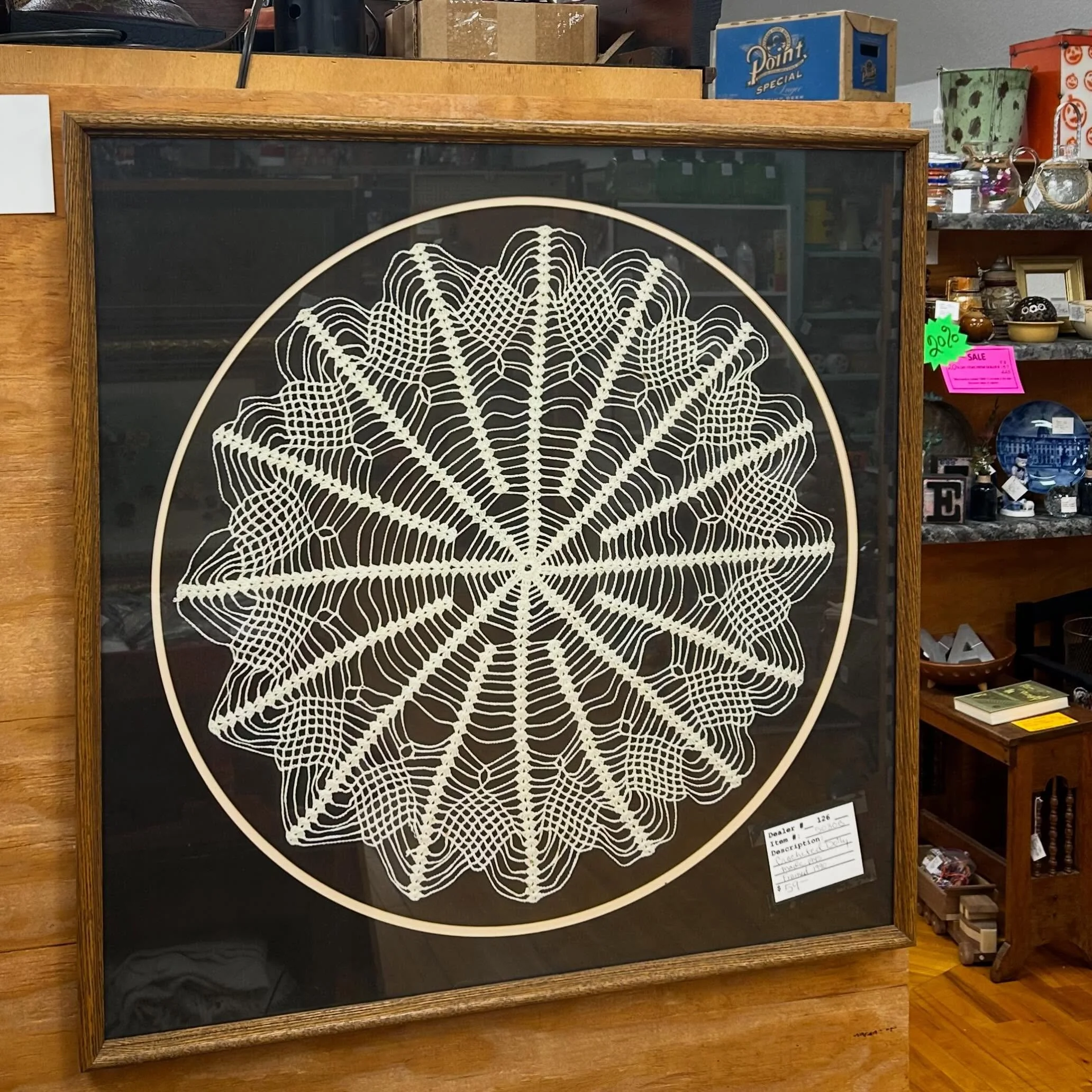 Classy framed vintage doily, or abstract spooky spiderweb? 🤔 You buy it and it&rsquo;s whatever you want it to be! 😜 Come see us today from 10-5! 🌈🪩⚡️
