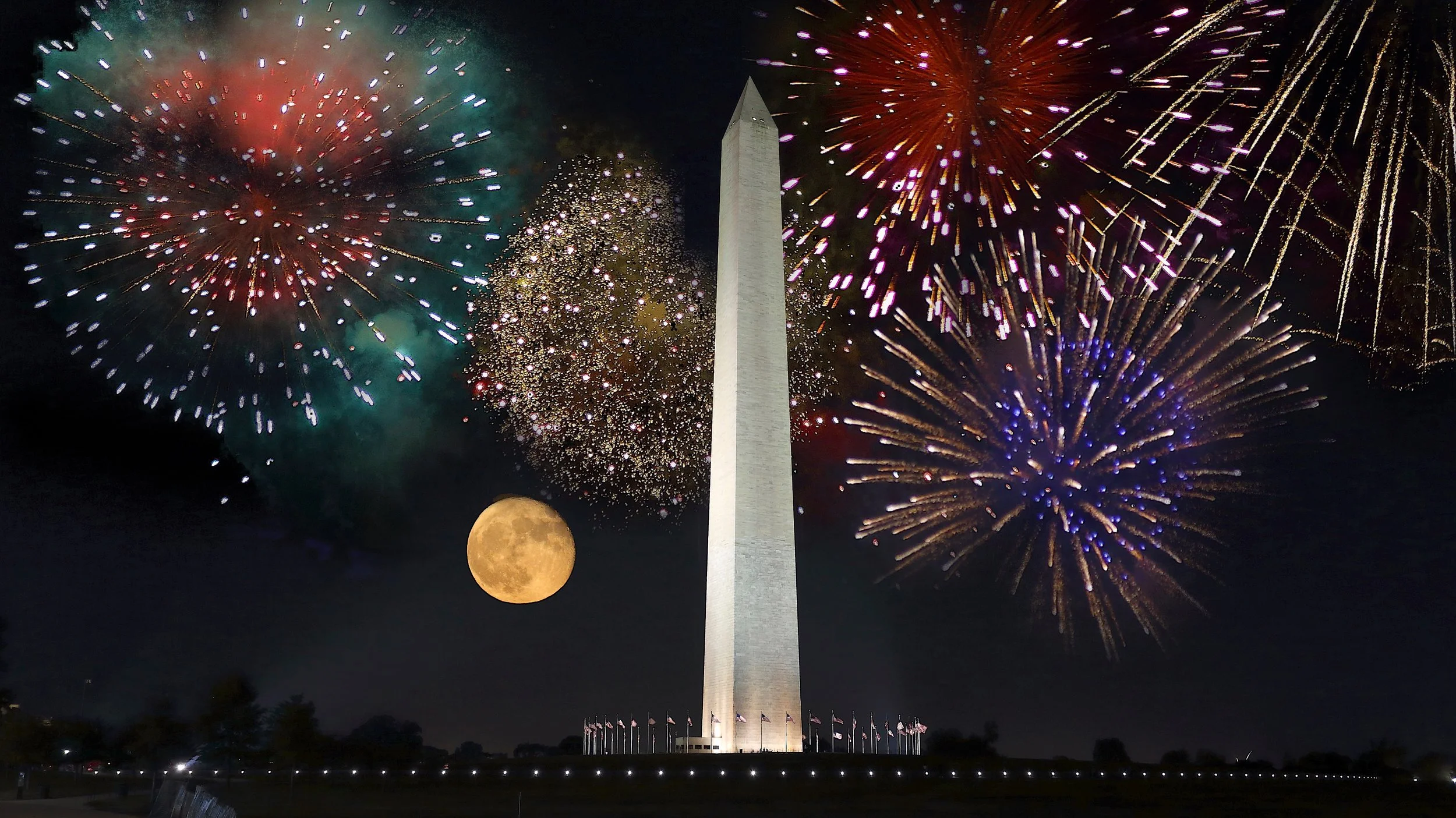Fireworks explode in the night sky behind the Washington Monument with a full moon nearby.