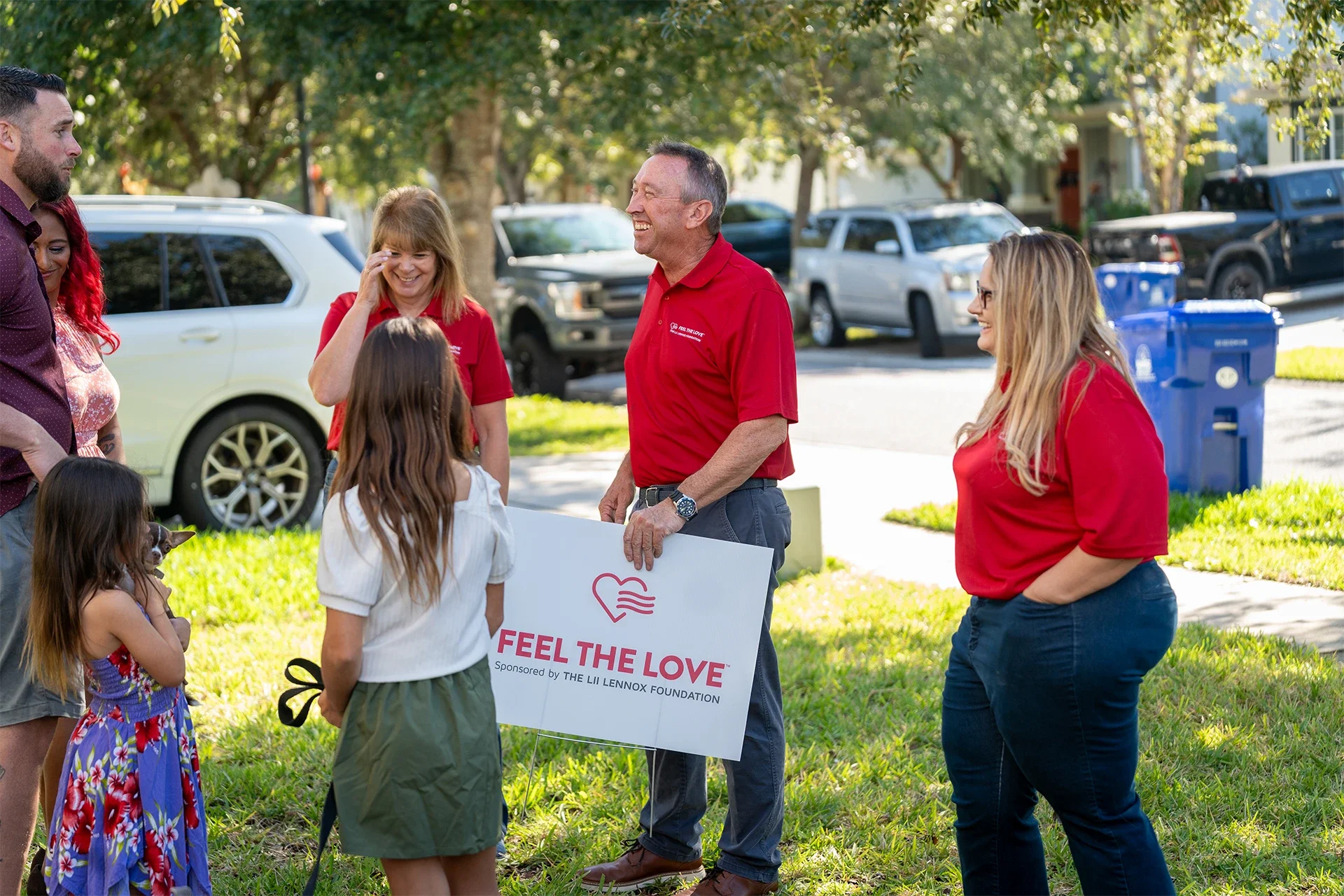 Thigpen leadership smiling while greeting a family for the "feel the love" campaign