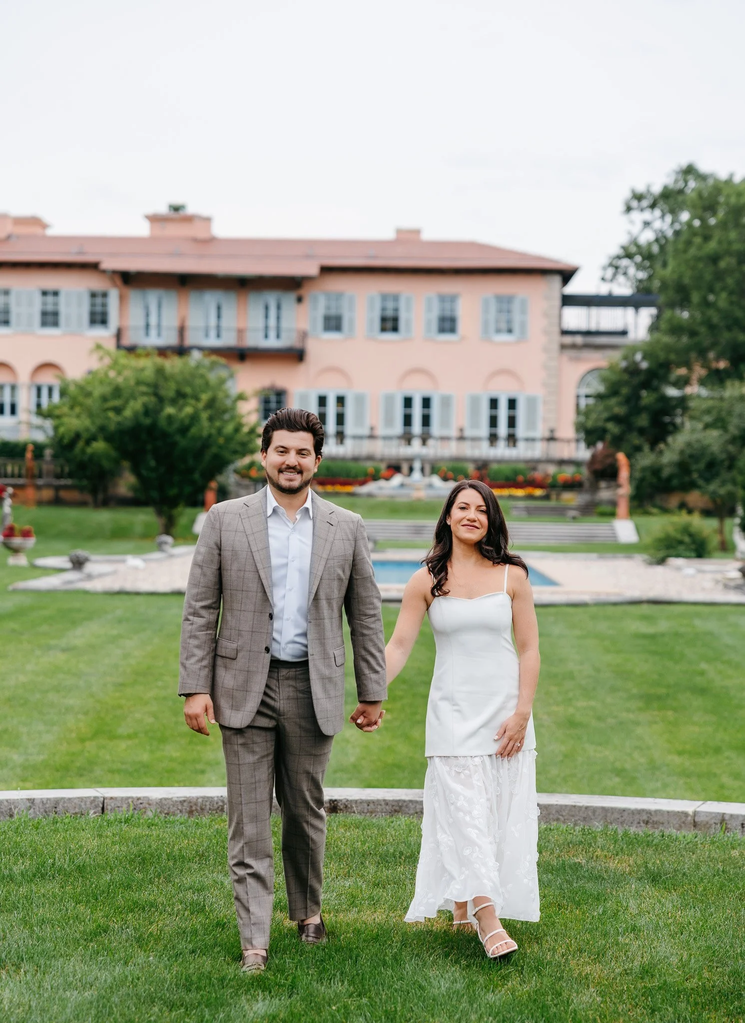 couple walking hand in hand at cuneo mansion