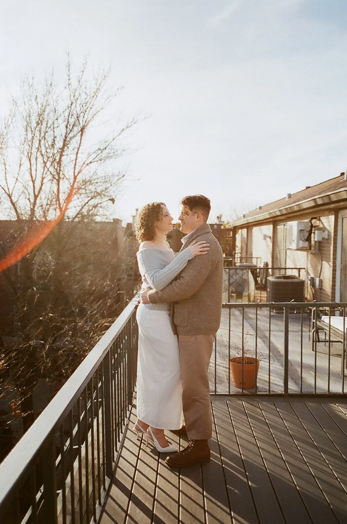 couple on their rooftop in chicago at sunset on film