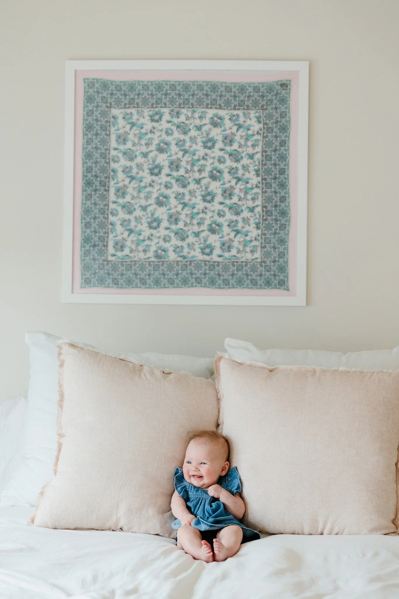 baby on bed in home family photo session