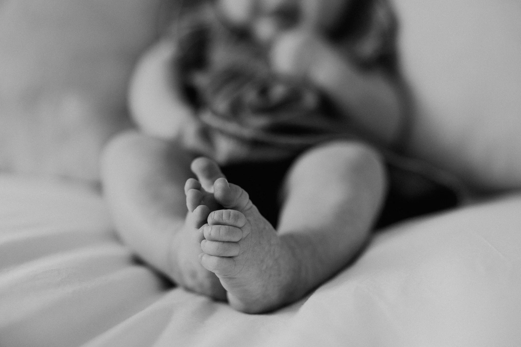 baby on bed in home family photo session
