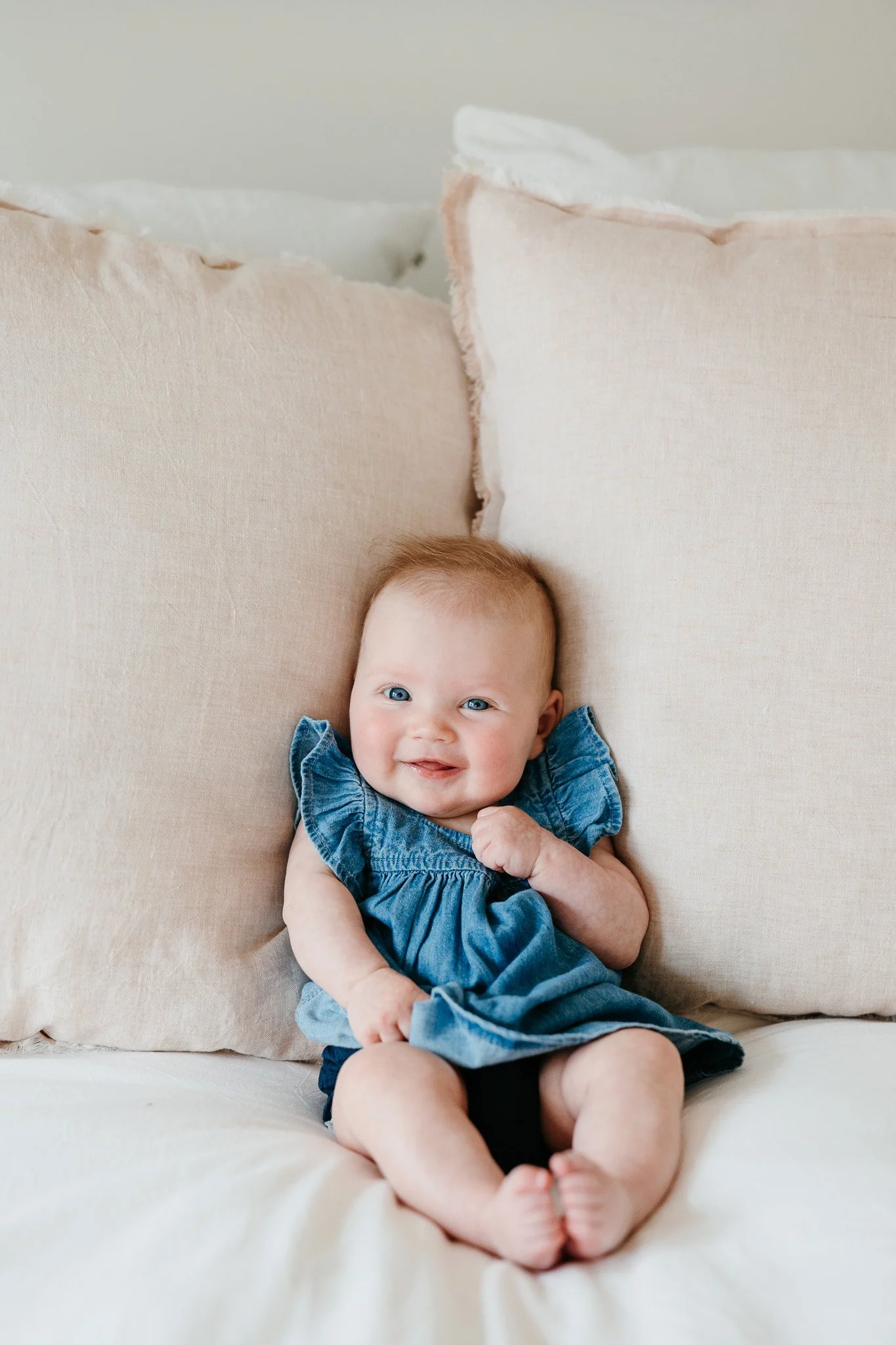baby on bed in home family photo session