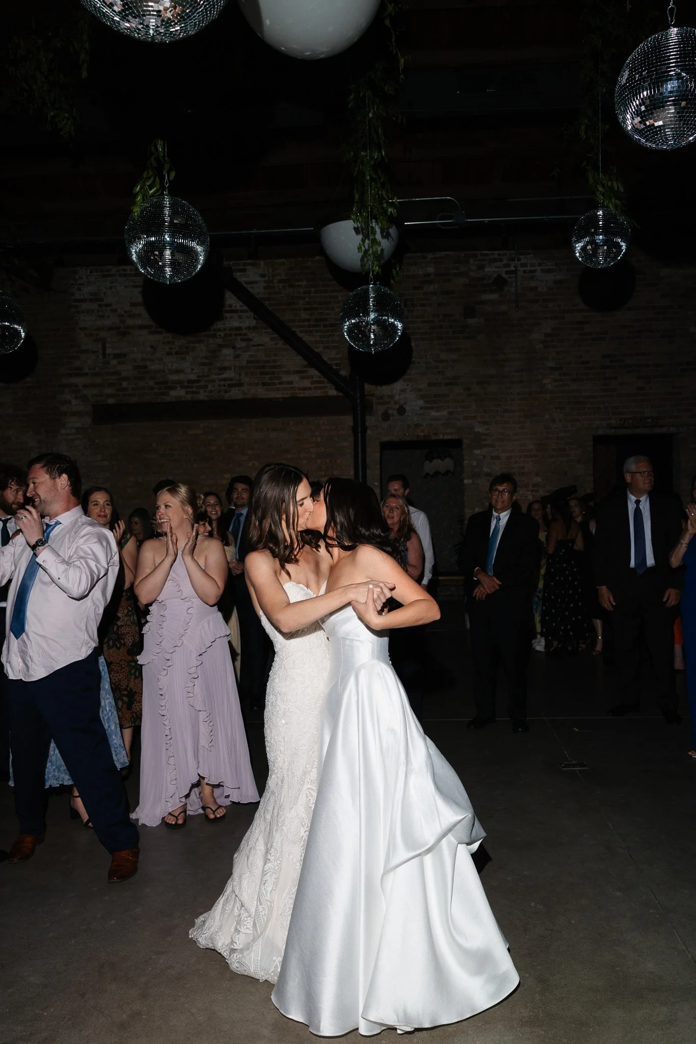 brides kiss on dance floor