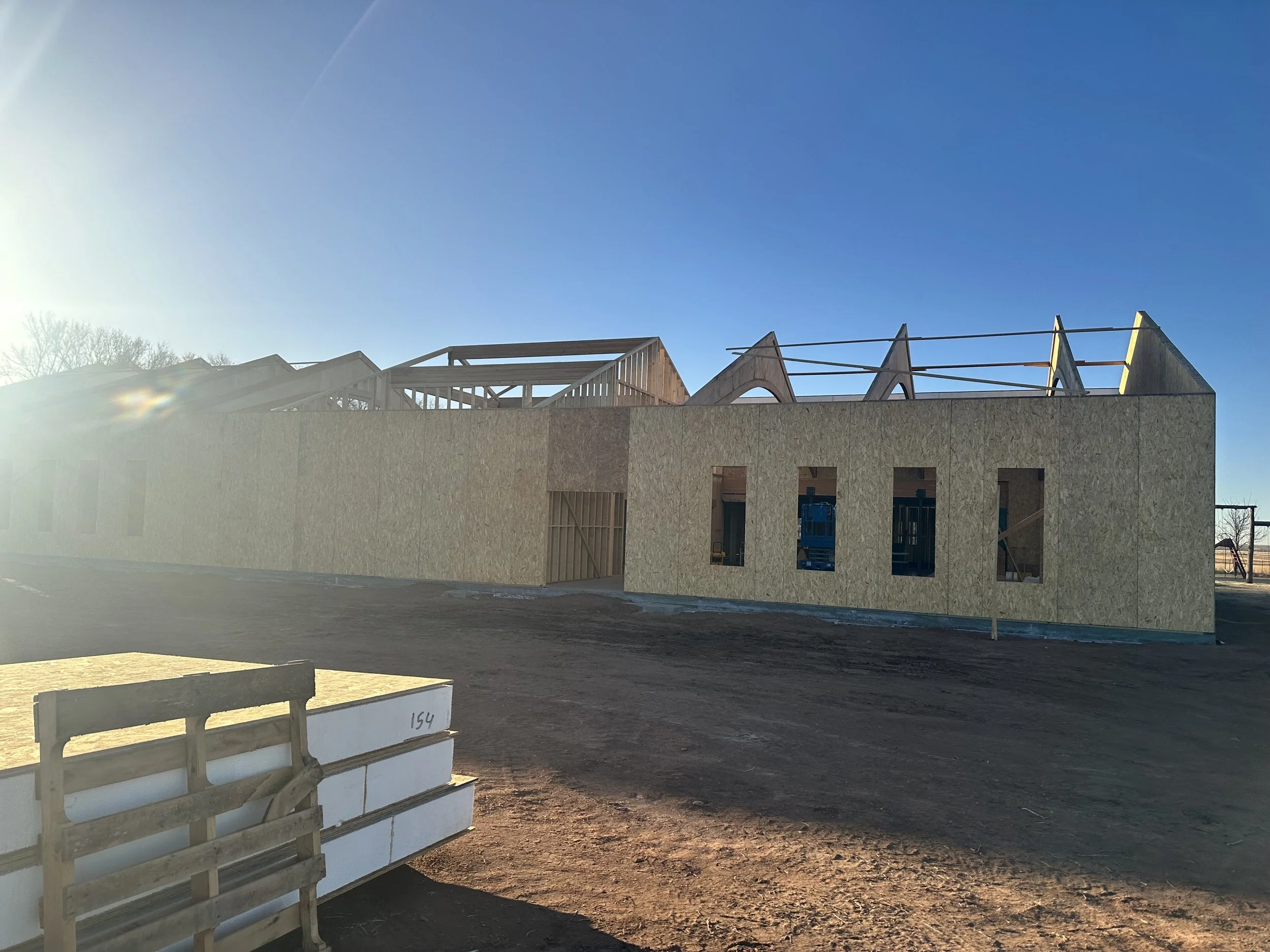Structural insulated panel (SIP) wall being installed on a residential construction site