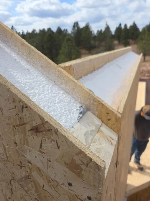 SIP wall panel installation showing continuous insulation with no thermal bridging.