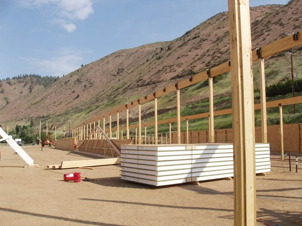 Cross-section view of a SIP showing OSB facings bonded to rigid foam insulation core.