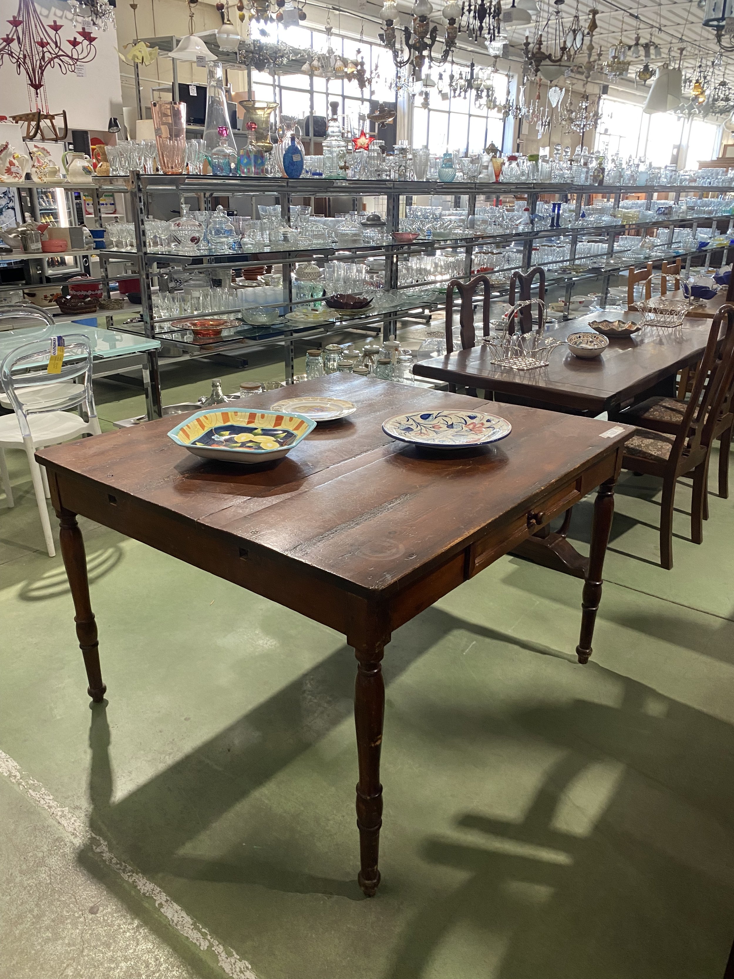 Antique dark wood dining table sourced in Tuscany by Yvonne Koné.