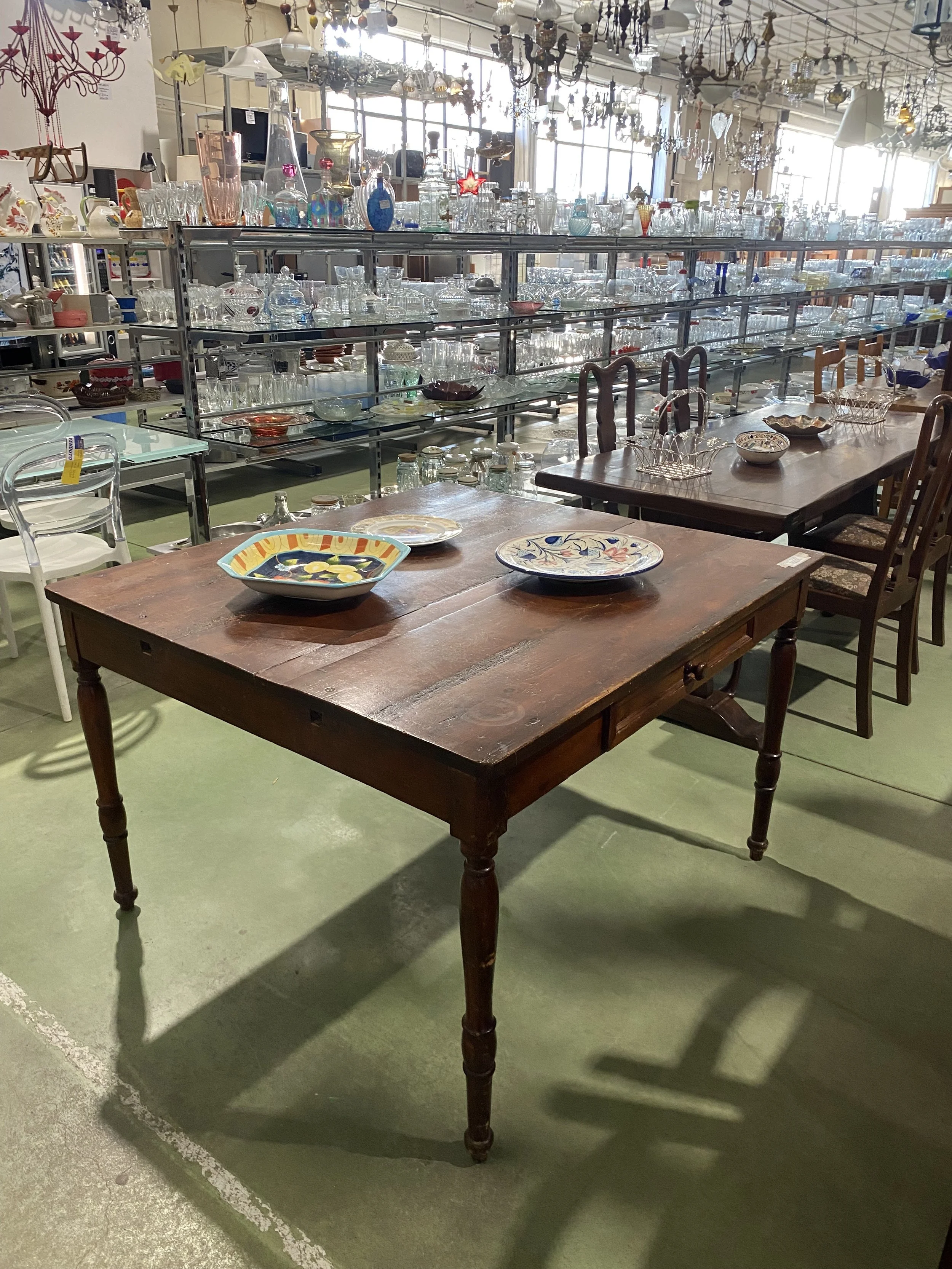 Antique dark wood dining table sourced in Tuscany by Yvonne Koné.