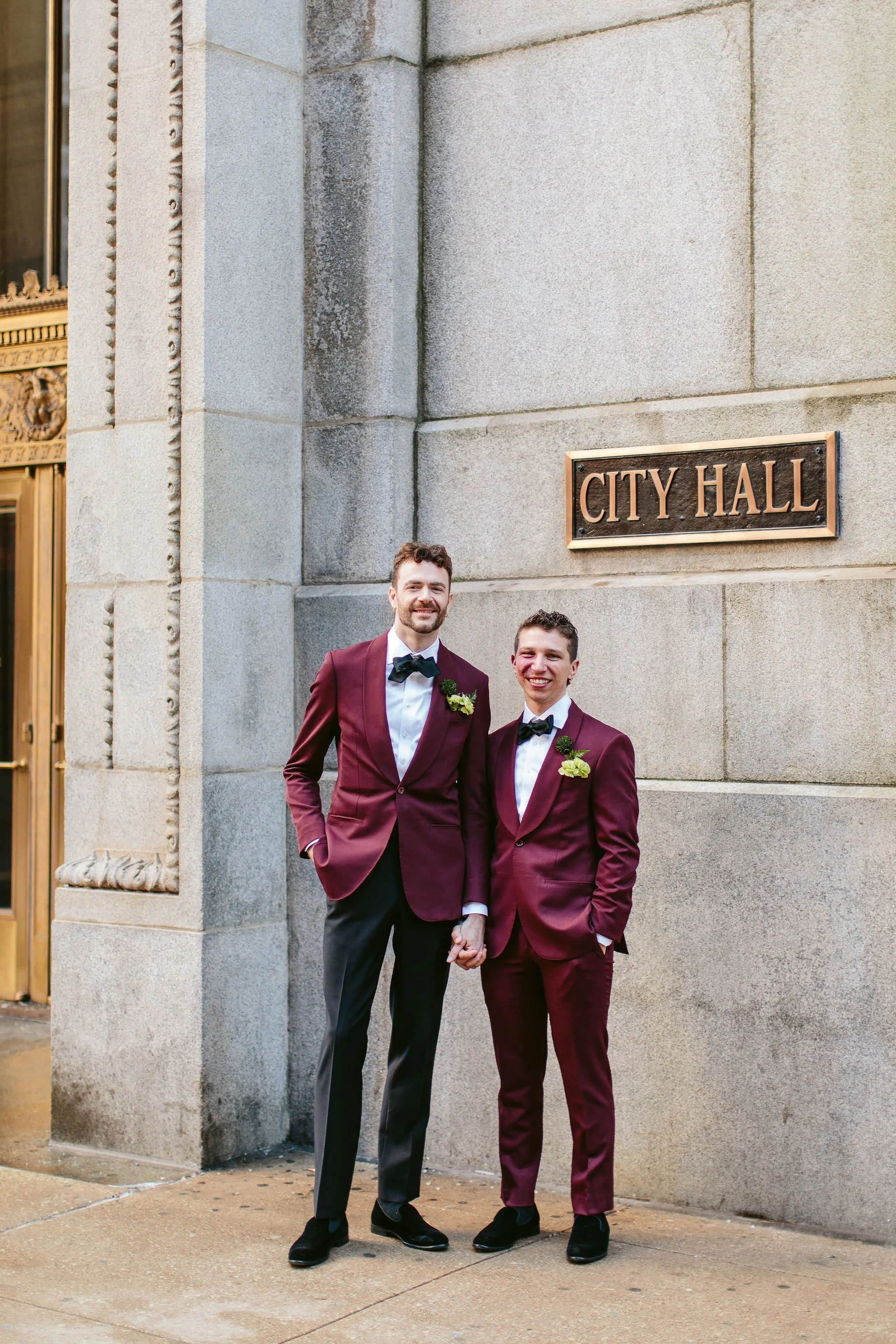 grooms in front of city hall sign in chicago