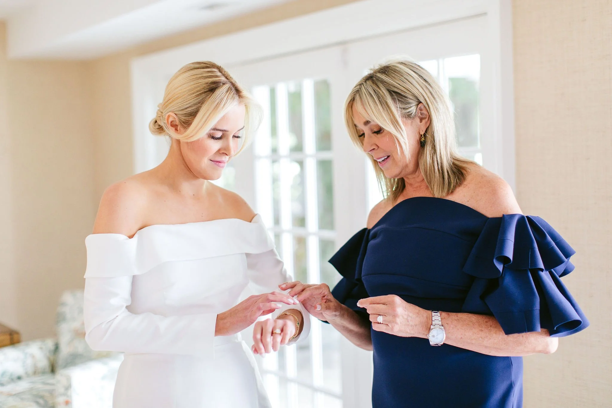 bride's mom helping her get ready