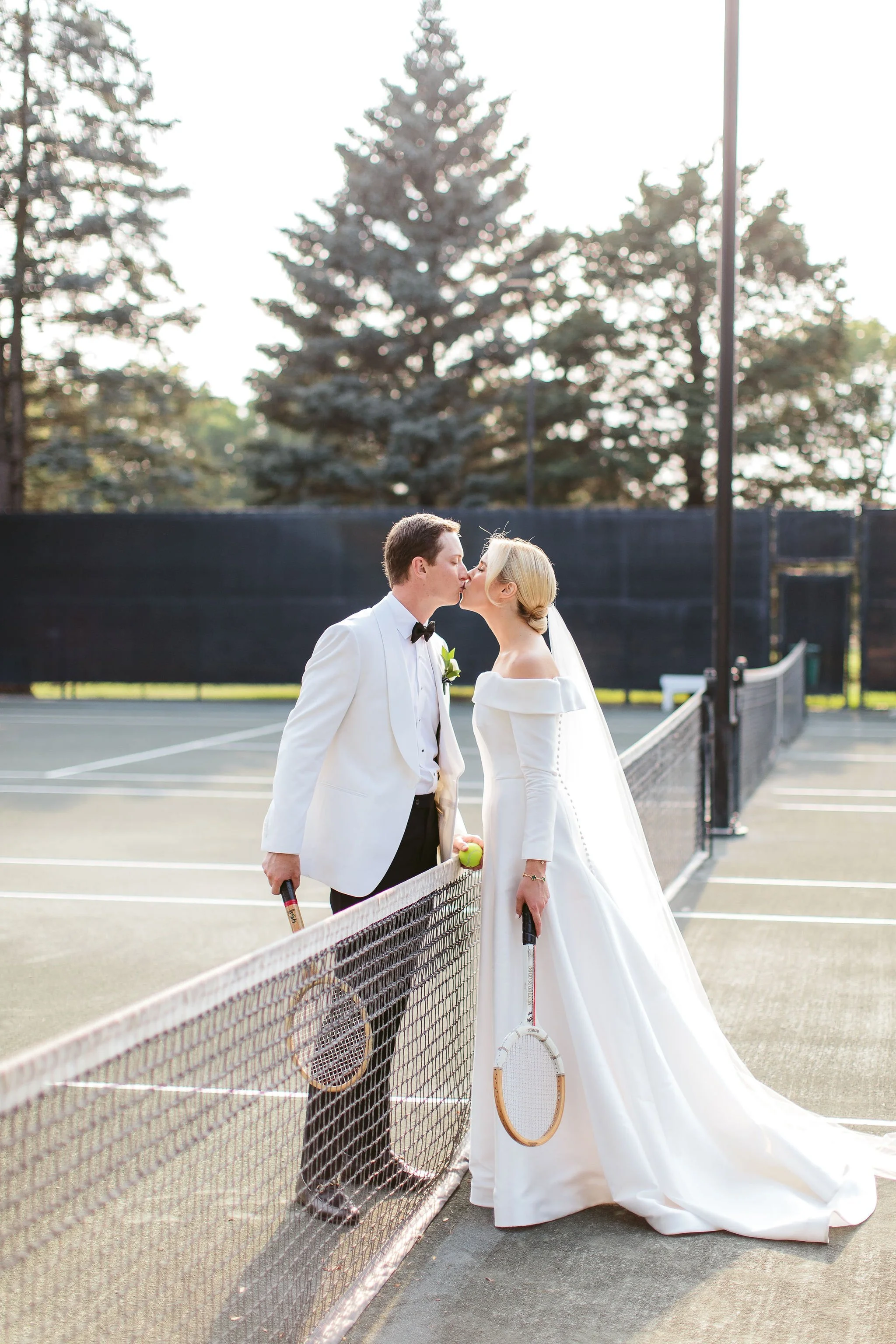 bride and groom kissing over net chicago wedding