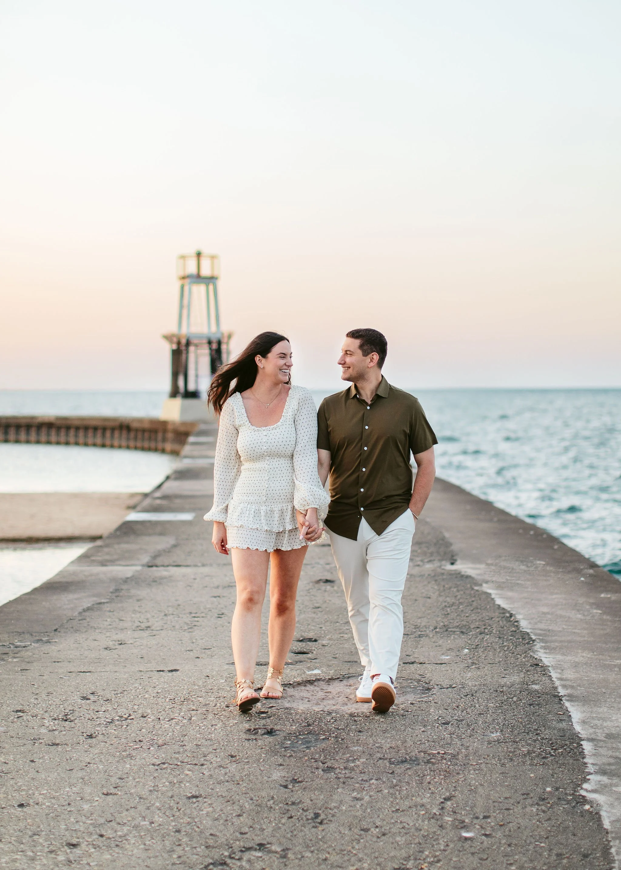 Engagement photo with small lighthouse in the background