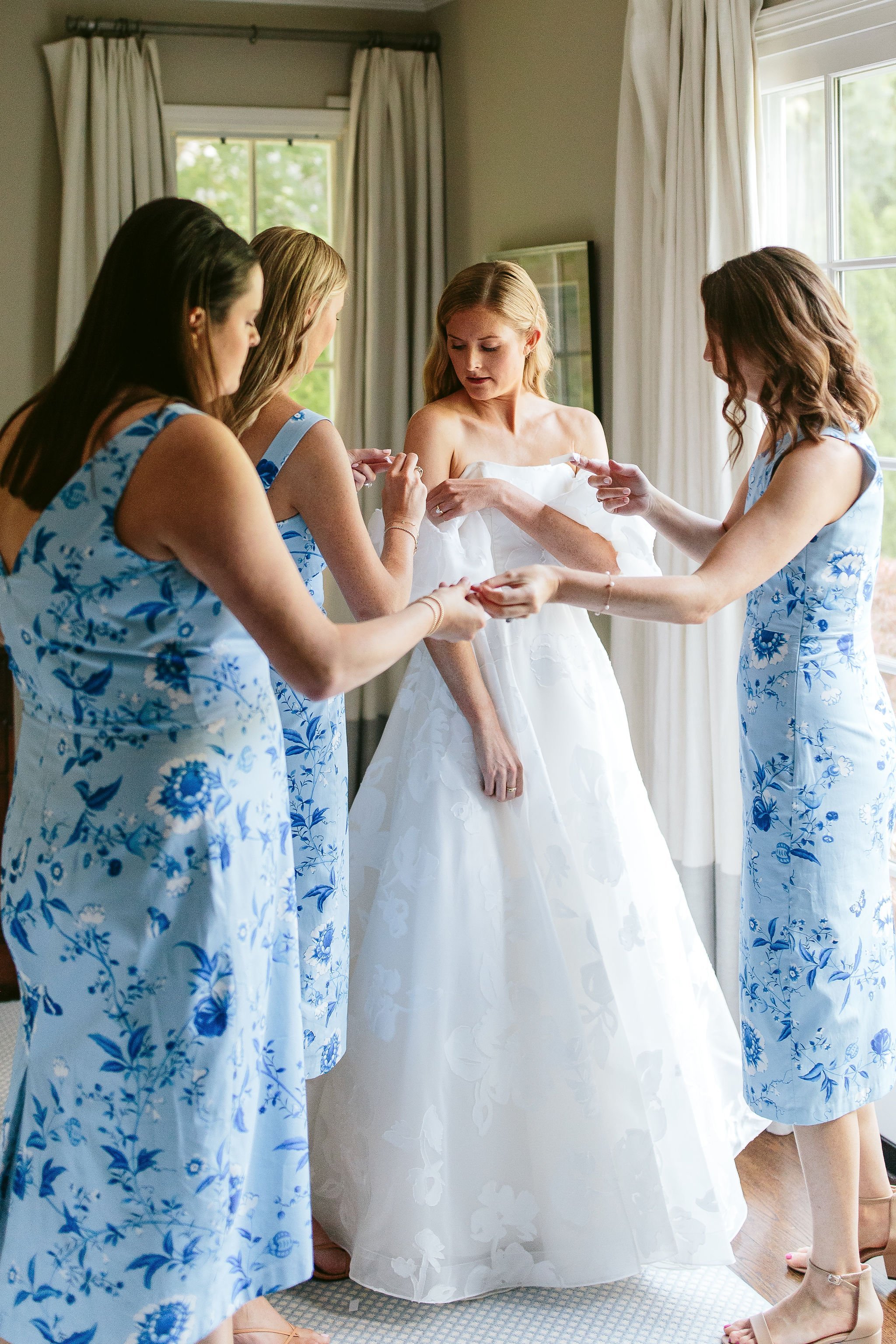 Chicago bride putting on Lea-ann Belter wedding dress