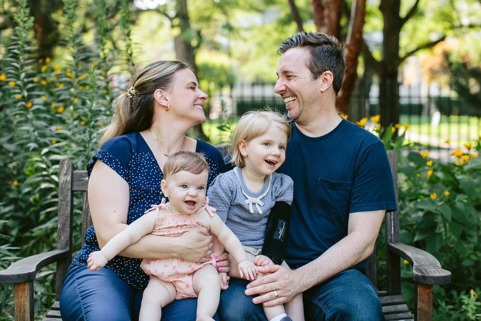 parents and two young children laugh during a family session in Oak Park, IL
