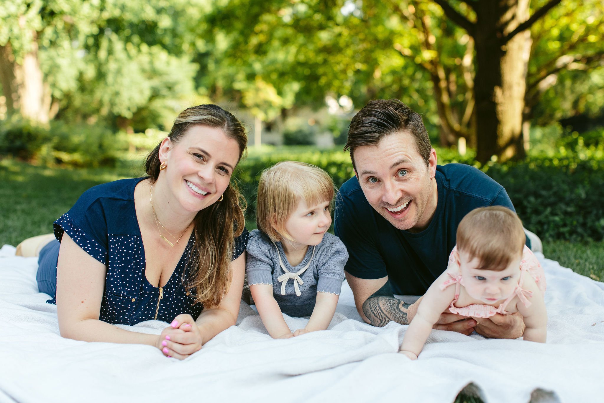 family laying on their stomachs, posing for a photo at the Cheney Mansion