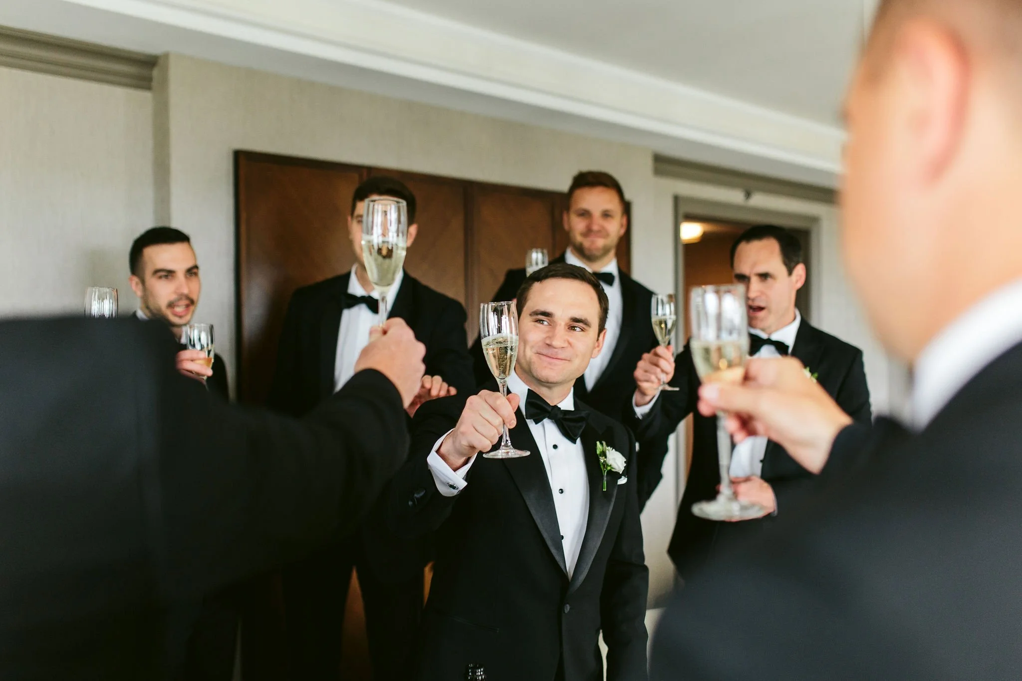 groom and groomsmen cheering at chicago wedding