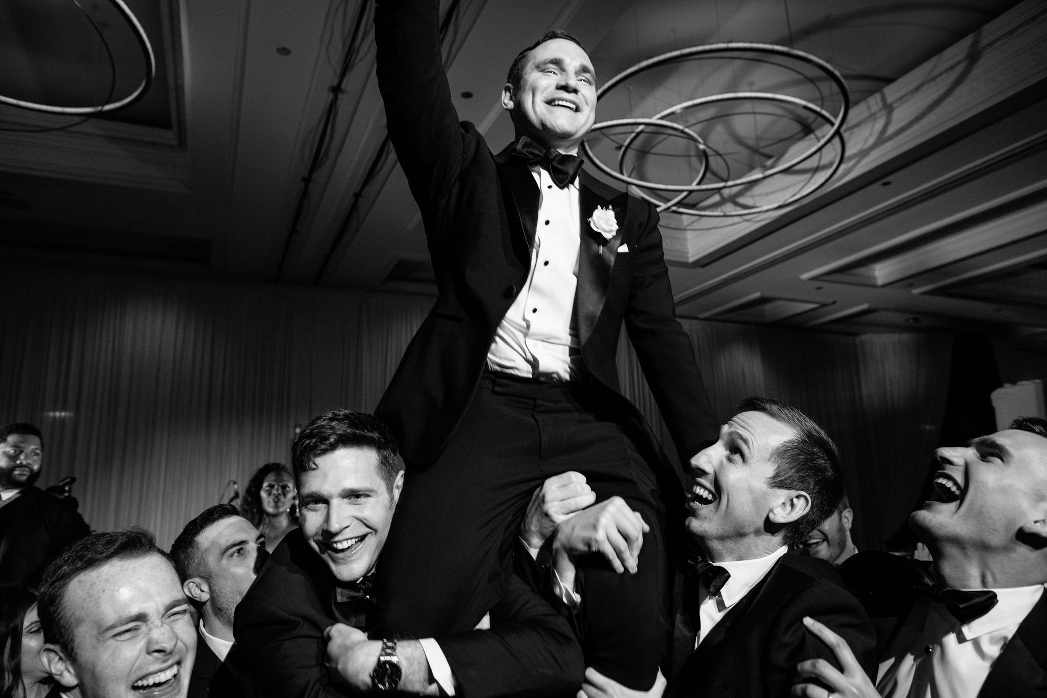 groom being lifted at chicago wedding