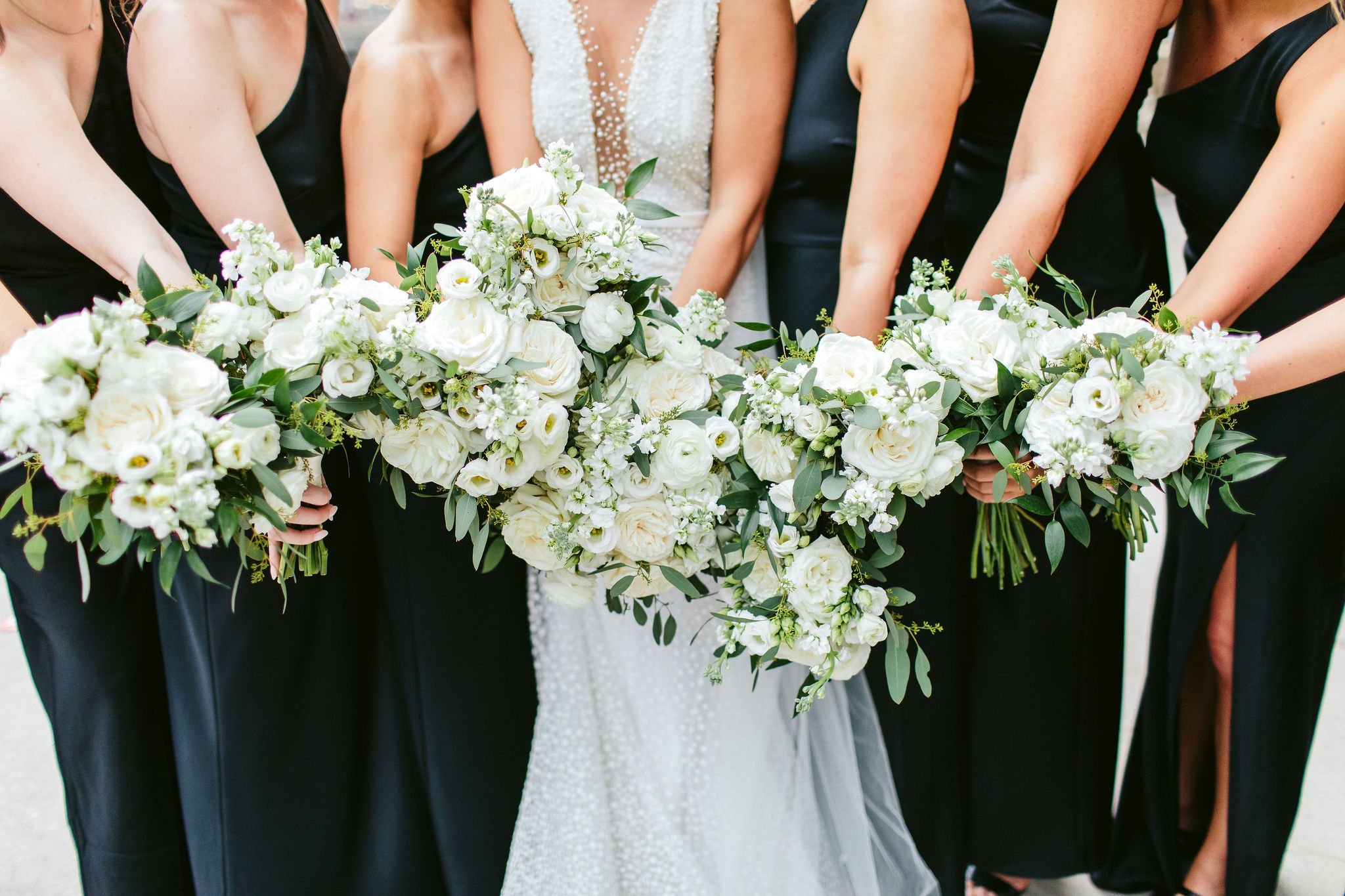 white bouquets with black dresses wedding