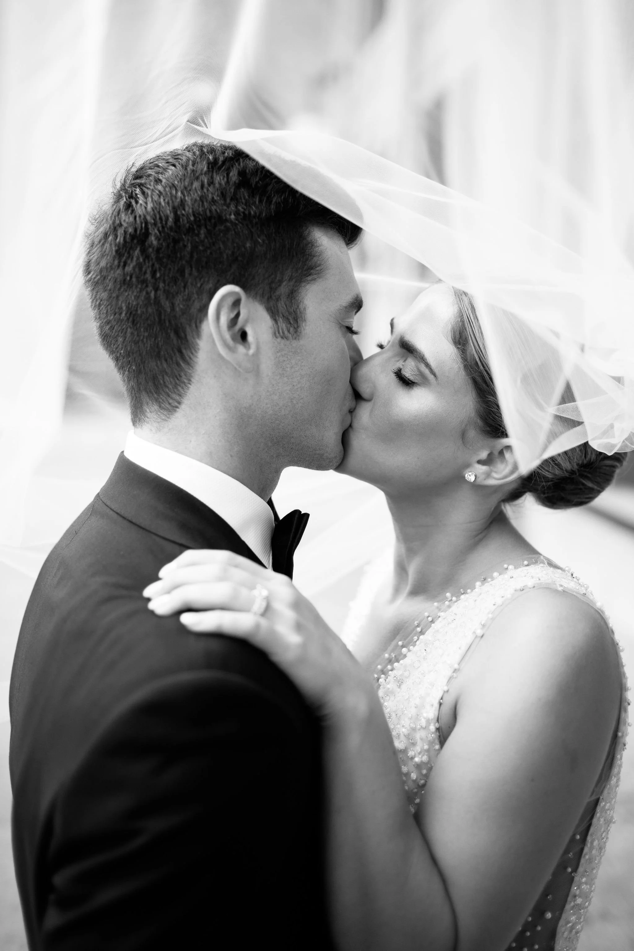 bride and groom with veil at chicago wedding