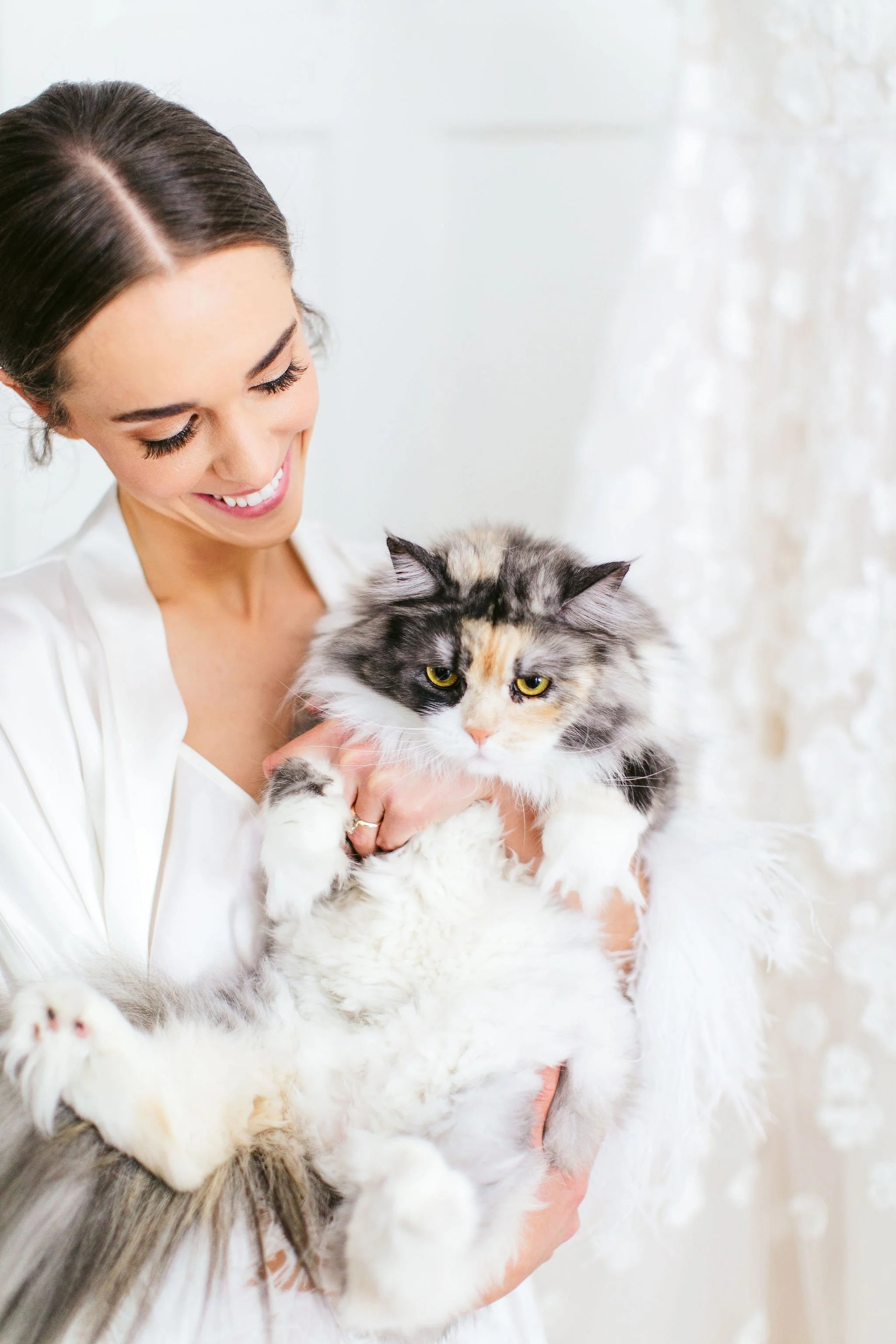 bride with her cat on wedding day