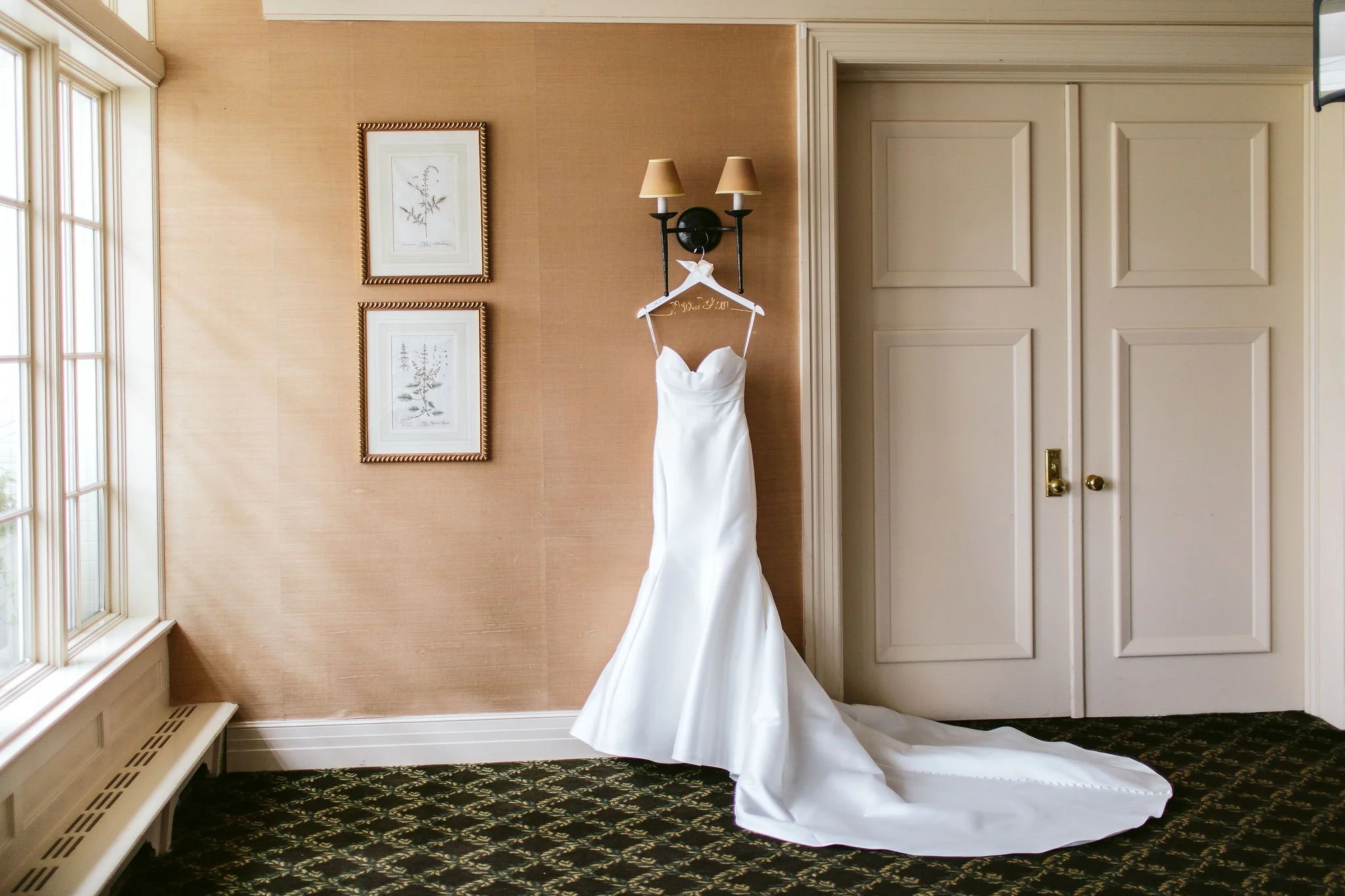 wedding dress against peach wall