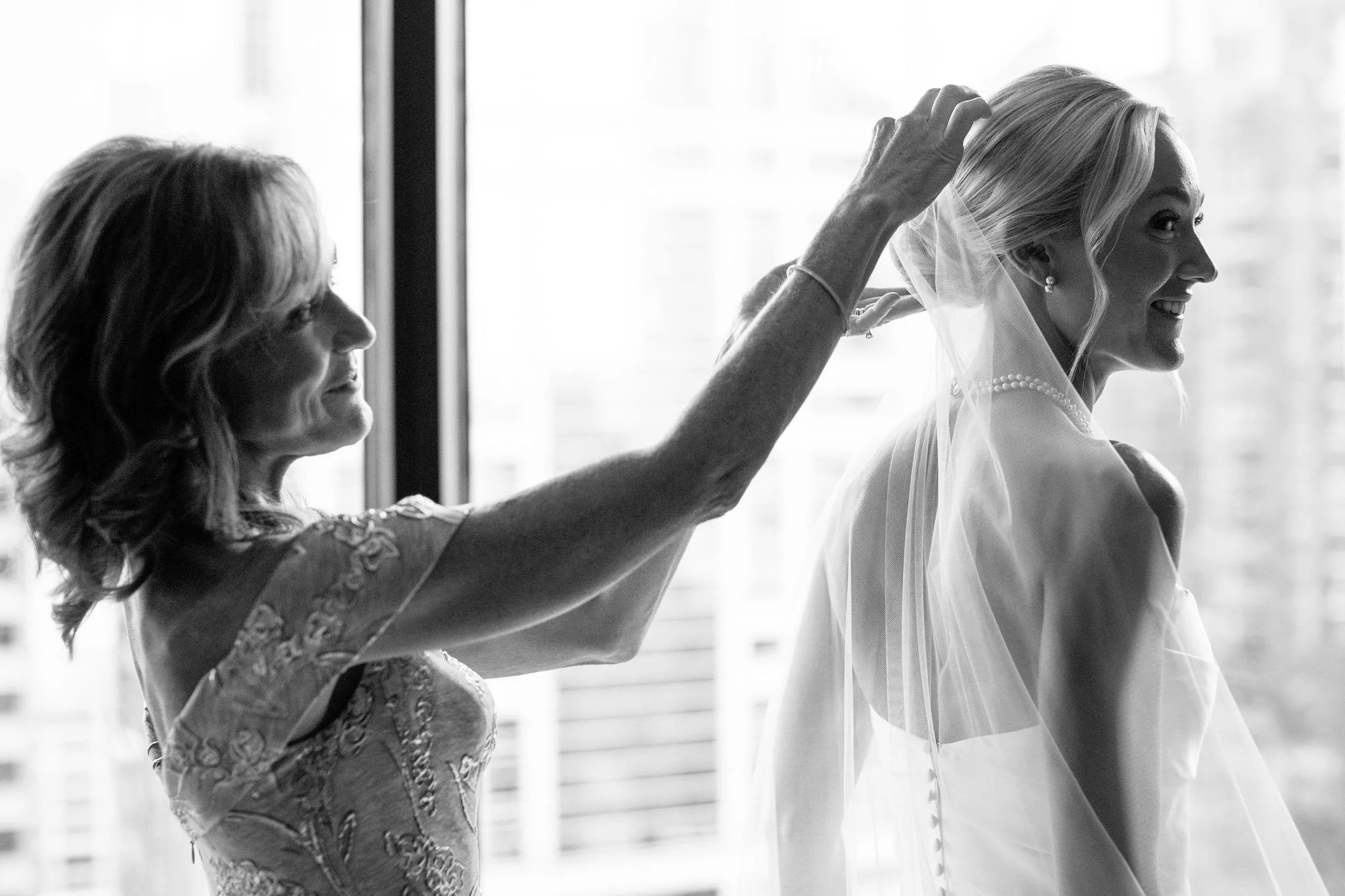 mom helping bride get dressed