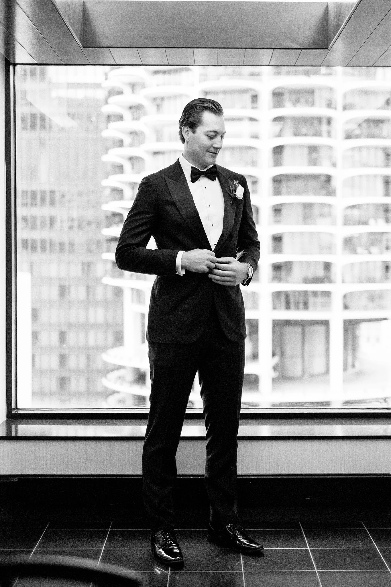 groom getting dressed with chicago backdrop